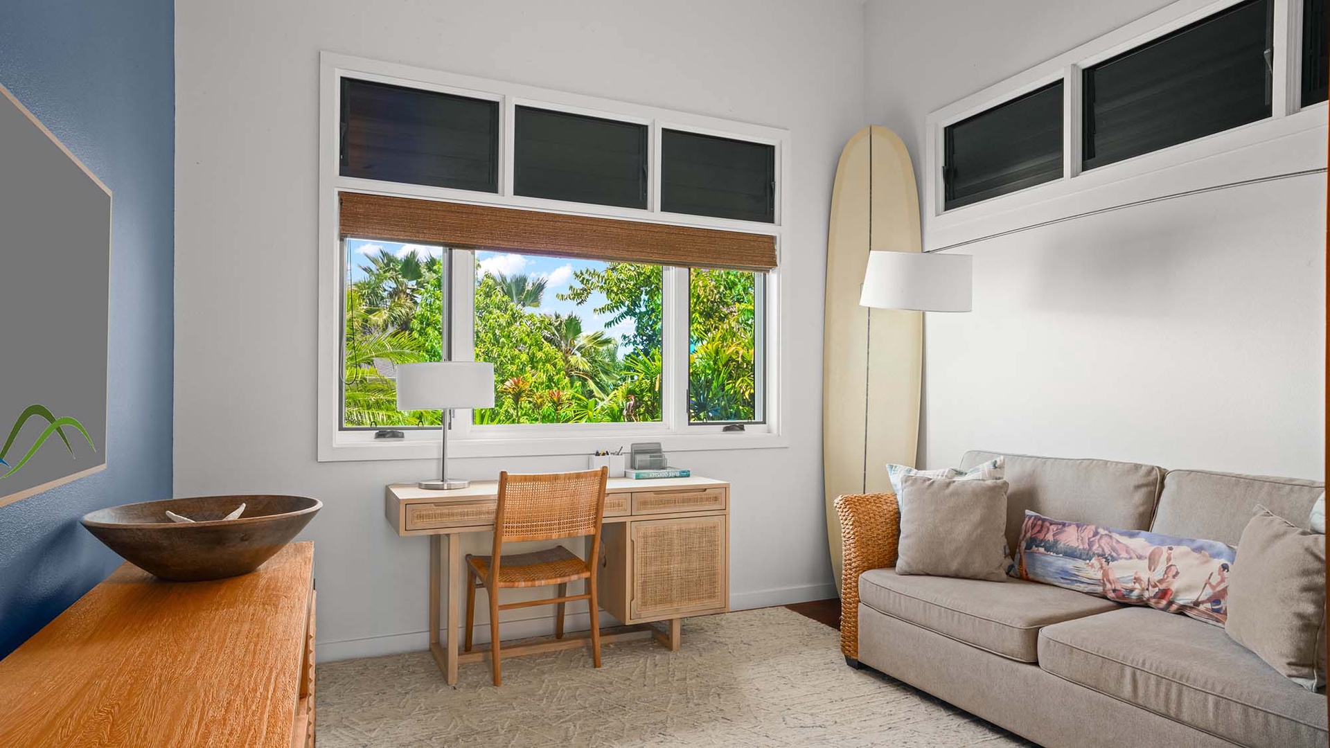 Your serene workspace awaits—enjoy natural light and lush tropical views as you unwind on the cozy sofa or catch up at your desk in this peaceful corner.
