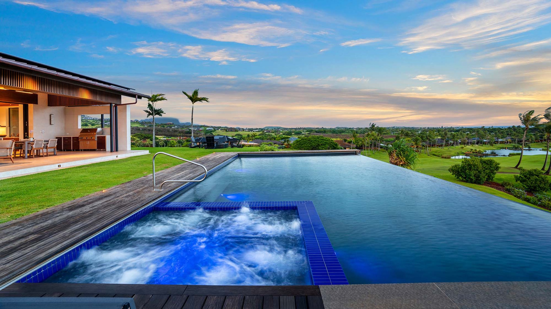 Soak in the infinity pool or bubbling hot tub while gazing across lush fairways and tropical palms—pure serenity awaits in your private backyard paradise.