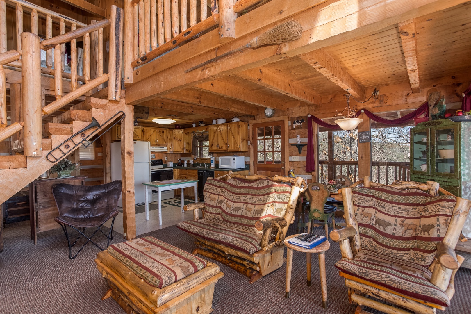 Living room with a loveseat and chair at Mountain Glory, a 1 bedroom cabin rental located in Pigeon Forge