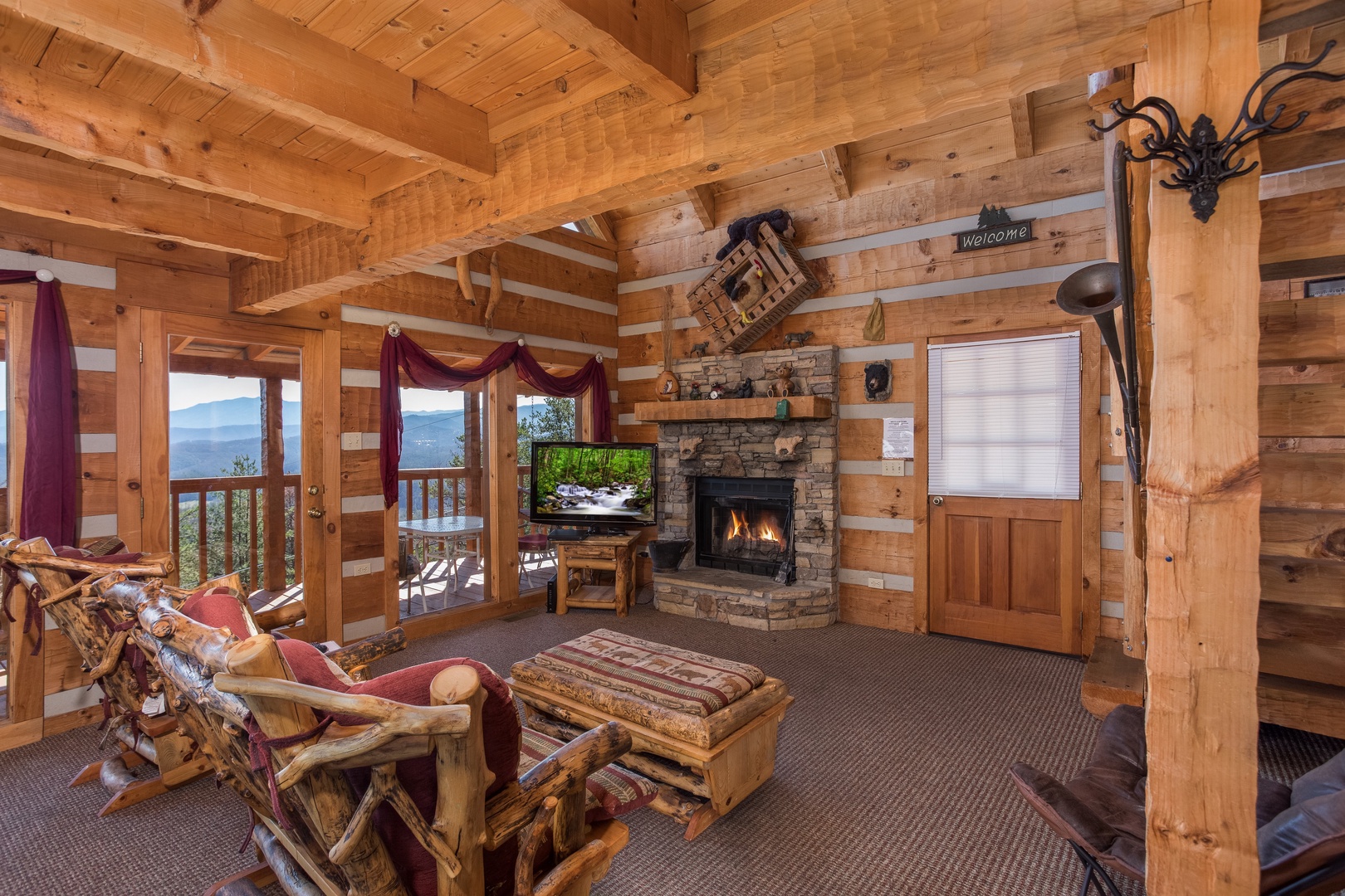 Living room with fireplace and TV at Mountain Glory, a 1 bedroom cabin rental located in Pigeon Forge