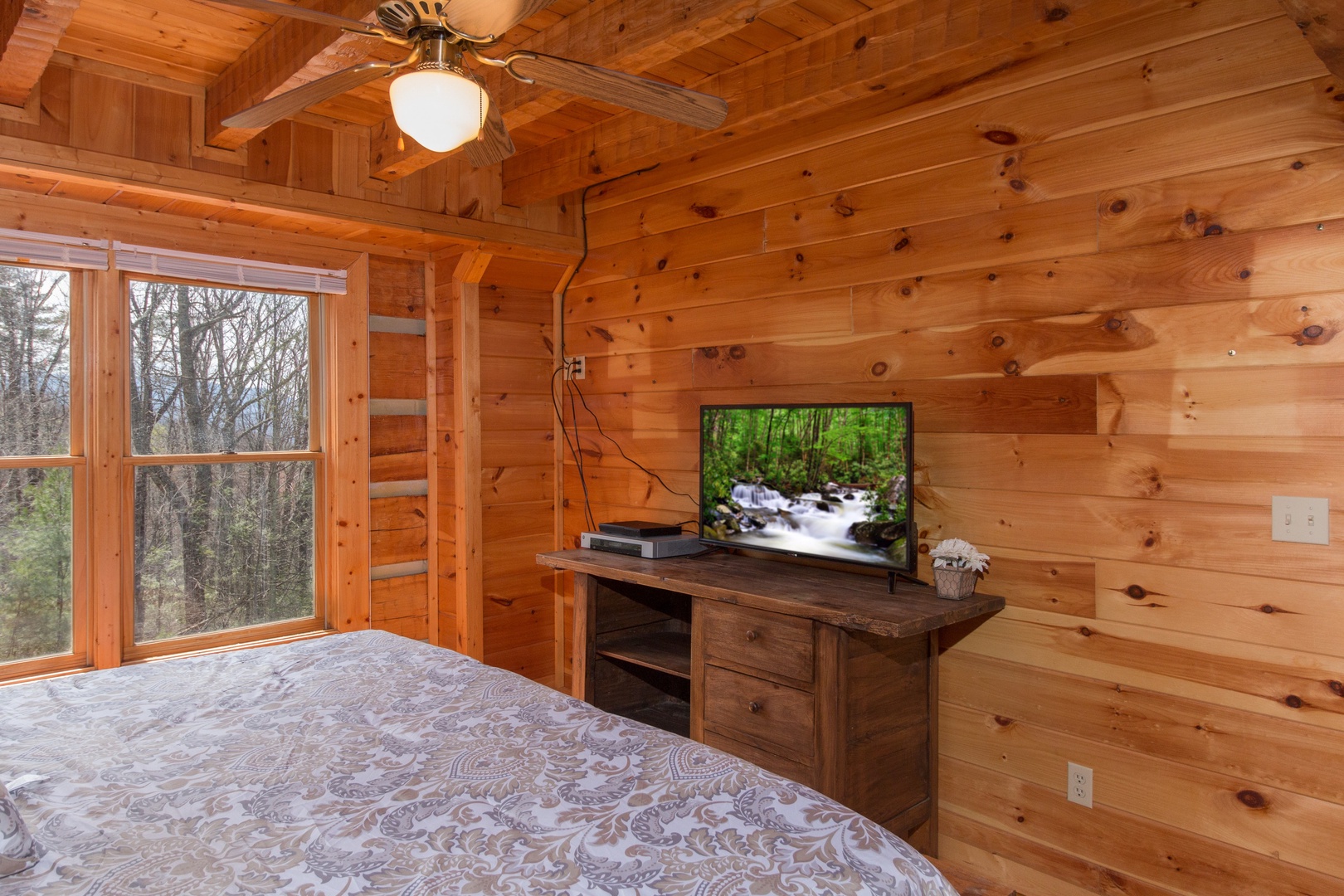 Console table and TV in a bedroom at Ella-Vation, a 3 bedroom cabin rental located in Gatlinburg