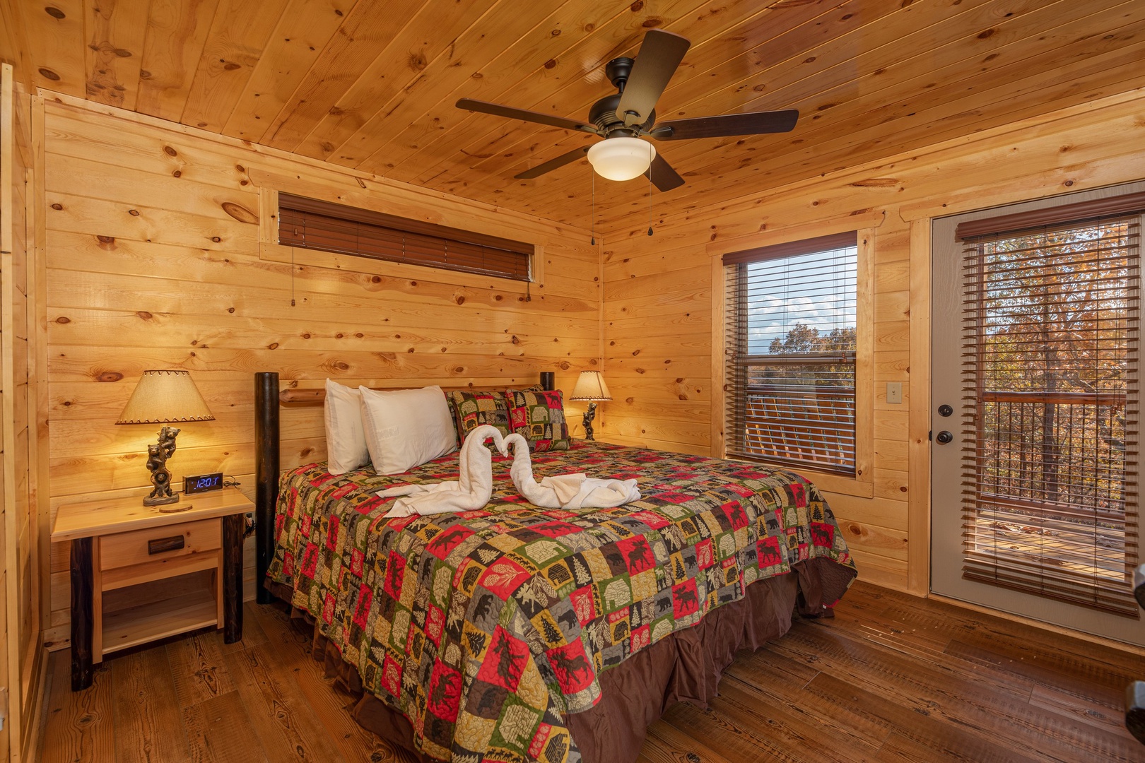 Bedroom with two night stands and lamps and deck access at Pinot Splash, a 4 bedroom cabin rental located in Gatlinburg