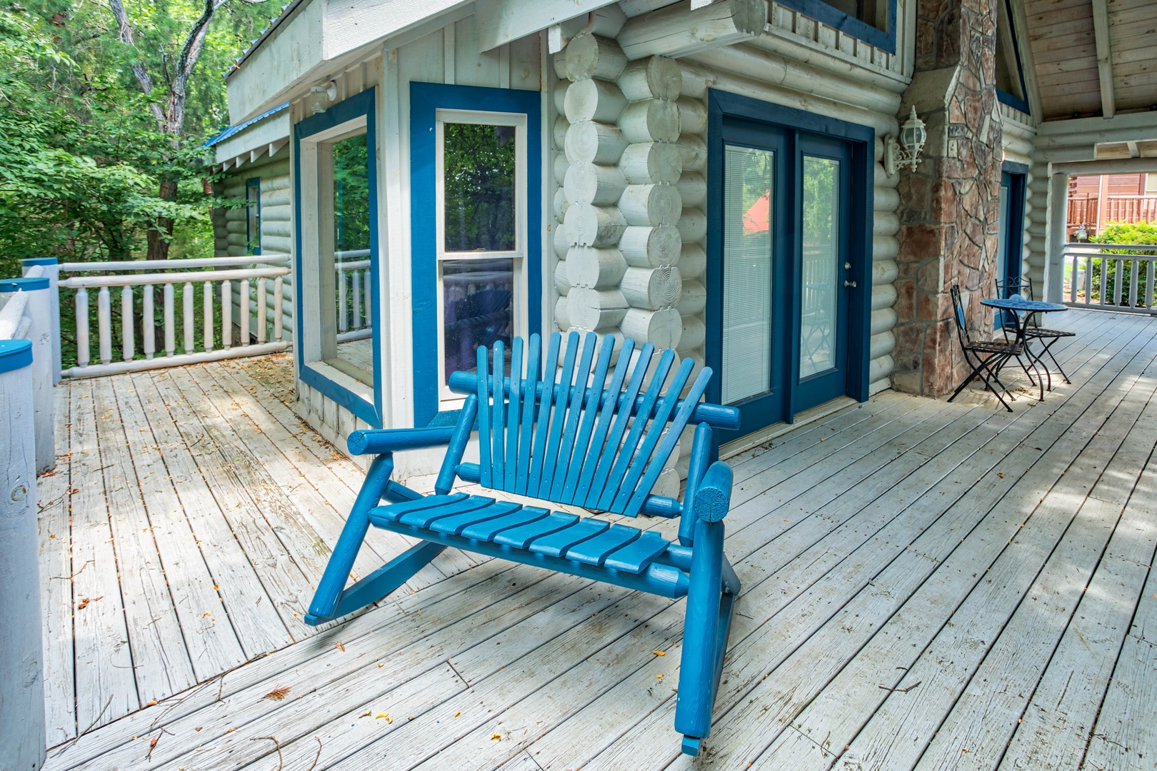 a blue log rocker on the deck at alpine something blue a 1 bedroom cabin rental located in pigeon forge
