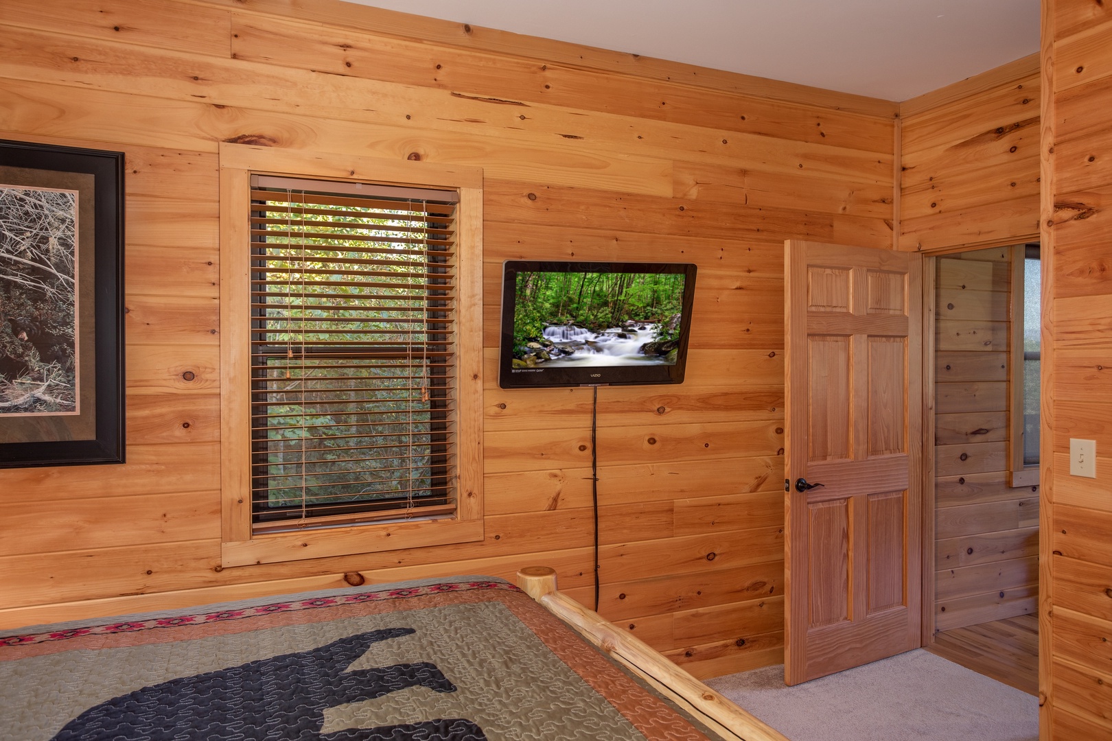 Wall mounted TV in a bedroom at Great View Lodge, a 5-bedroom cabin rental located in Pigeon Forge