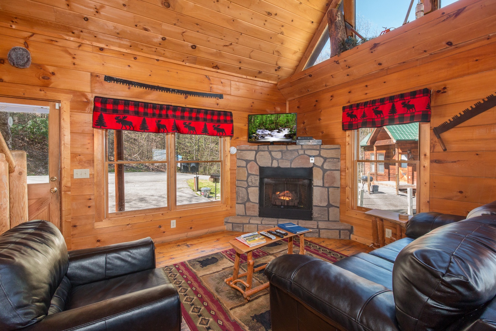 Living room with fireplace and TV at Lumber Jack Lodge, a 1 bedroom cabin rental located in Gatlinburg