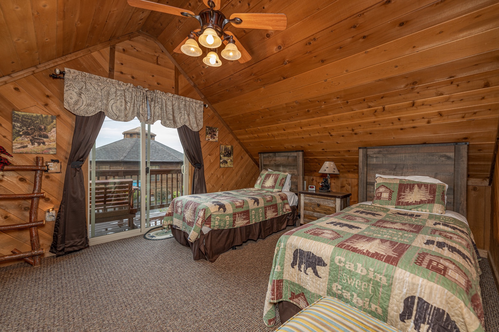 Bedroom with two twin beds and deck access at Bearing Views, a 3 bedroom cabin rental located in Pigeon Forge