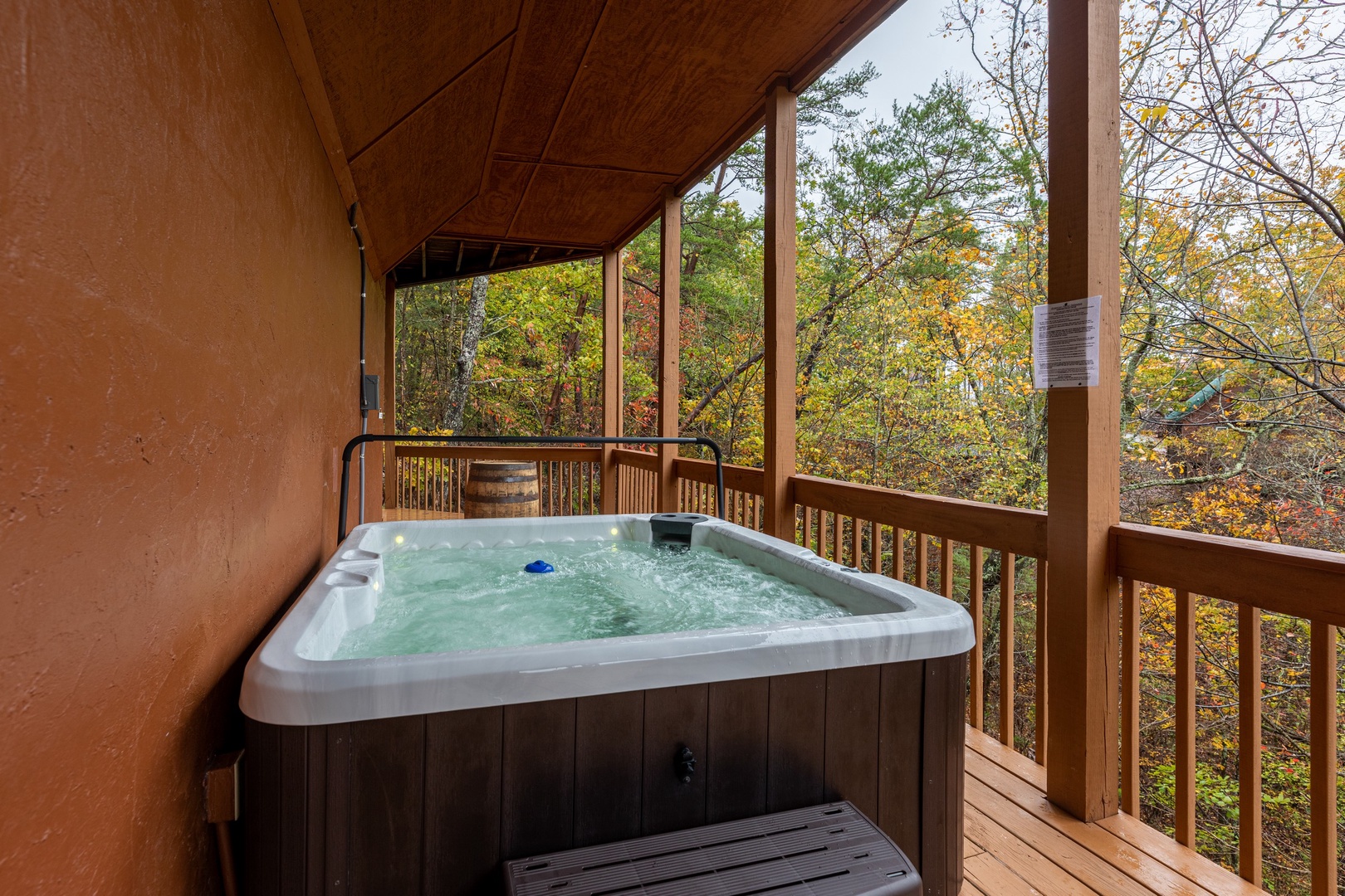 Hot tub on a covered deck at Lazy Bear Retreat, a 4 bedroom cabin rental located in Pigeon Forge
