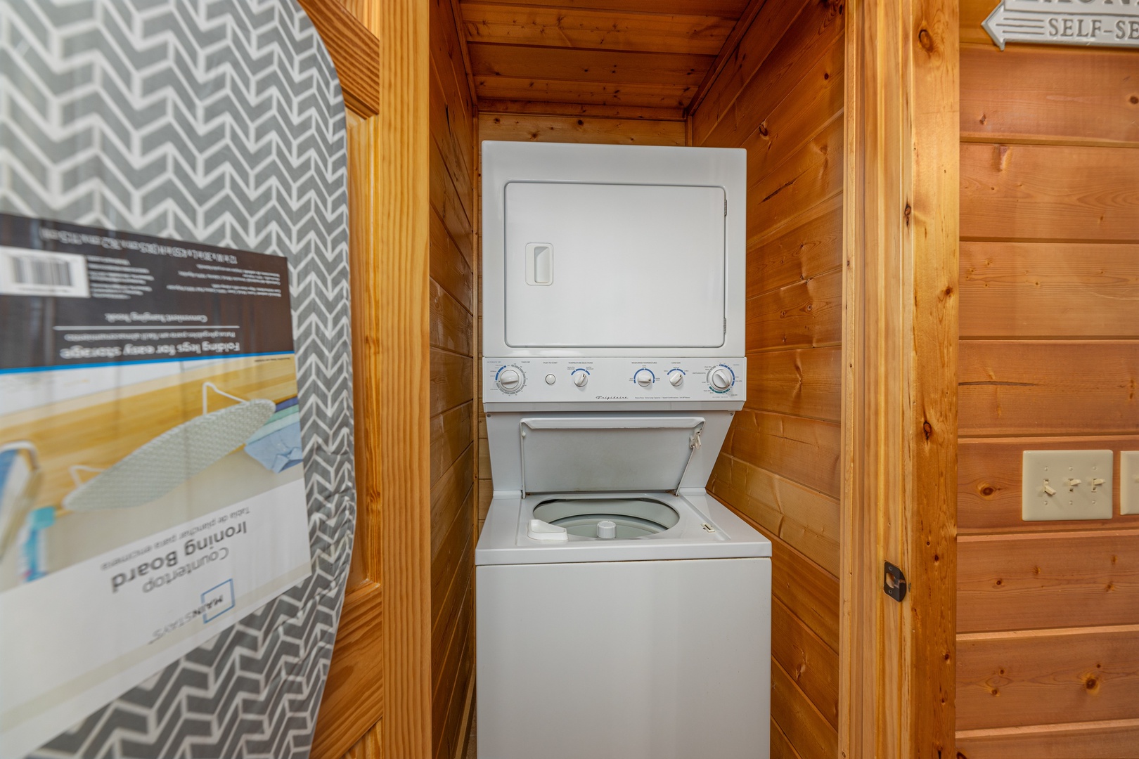 Stacked washer and dryer in a laundry closet at 3 Crazy Cubs, a 5 bedroom cabin rental located in Pigeon Forge