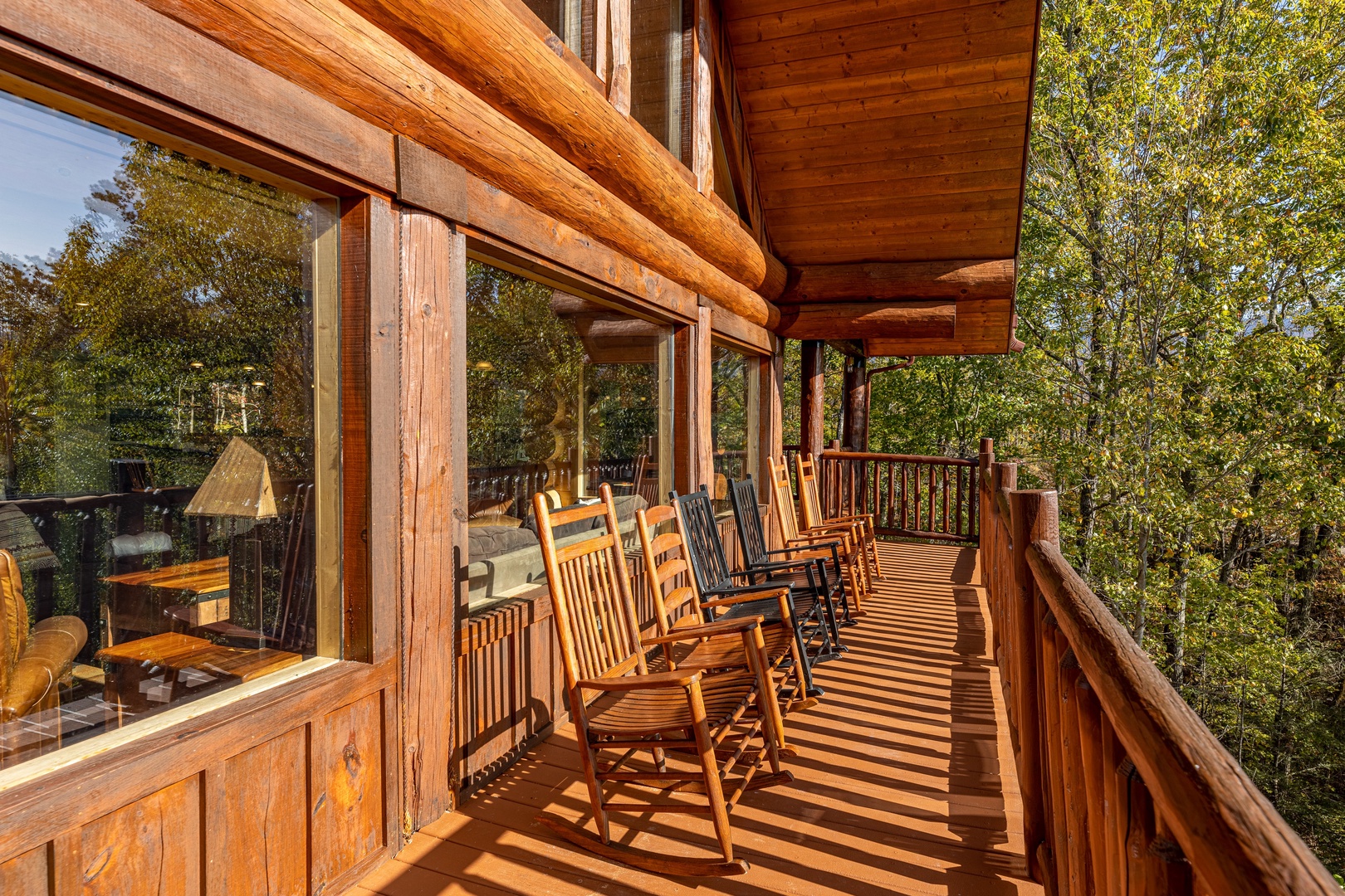 Rocking chairs on an open deck at Grizzly's Den, a 5 bedroom cabin rental located in Gatlinburg