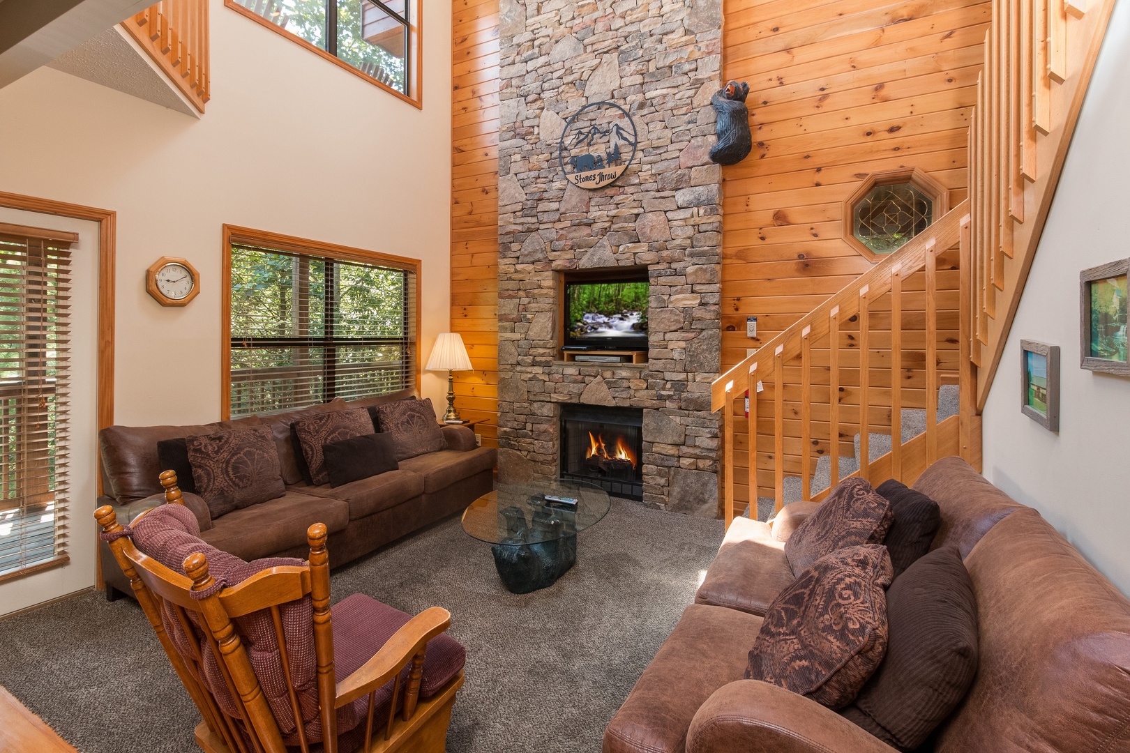 Living room with fireplace and TV at Stones Throw a 4 bedroom cabin rental located in pigeon forge