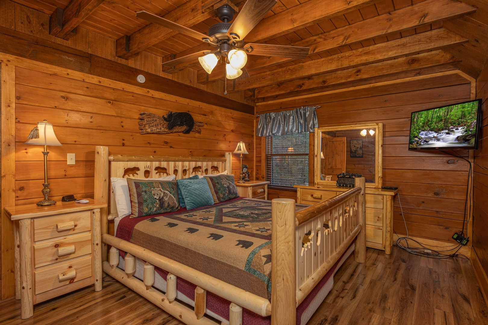 Dresser, night stand, and TV in a bedroom at Pigeon Forge Pleasures, a 3 bedroom cabin rental located in Pigeon Forge