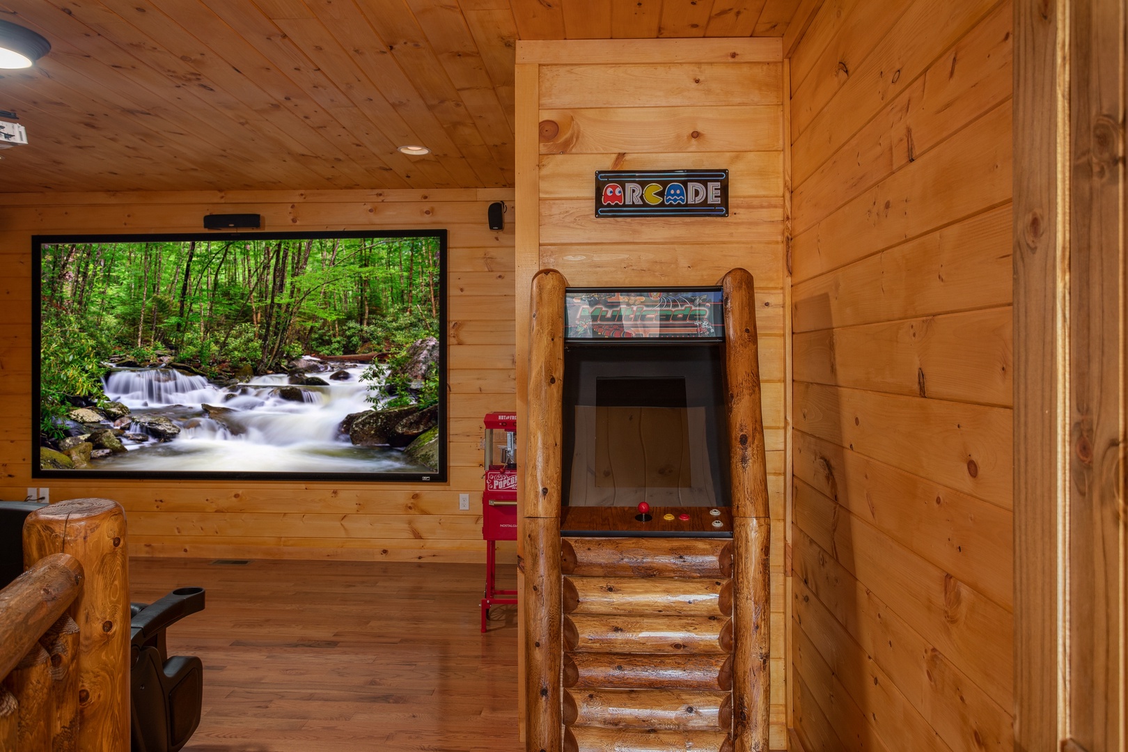 Arcade game in the theater room at Four Seasons Palace, a 5-bedroom cabin rental located in Pigeon Forge