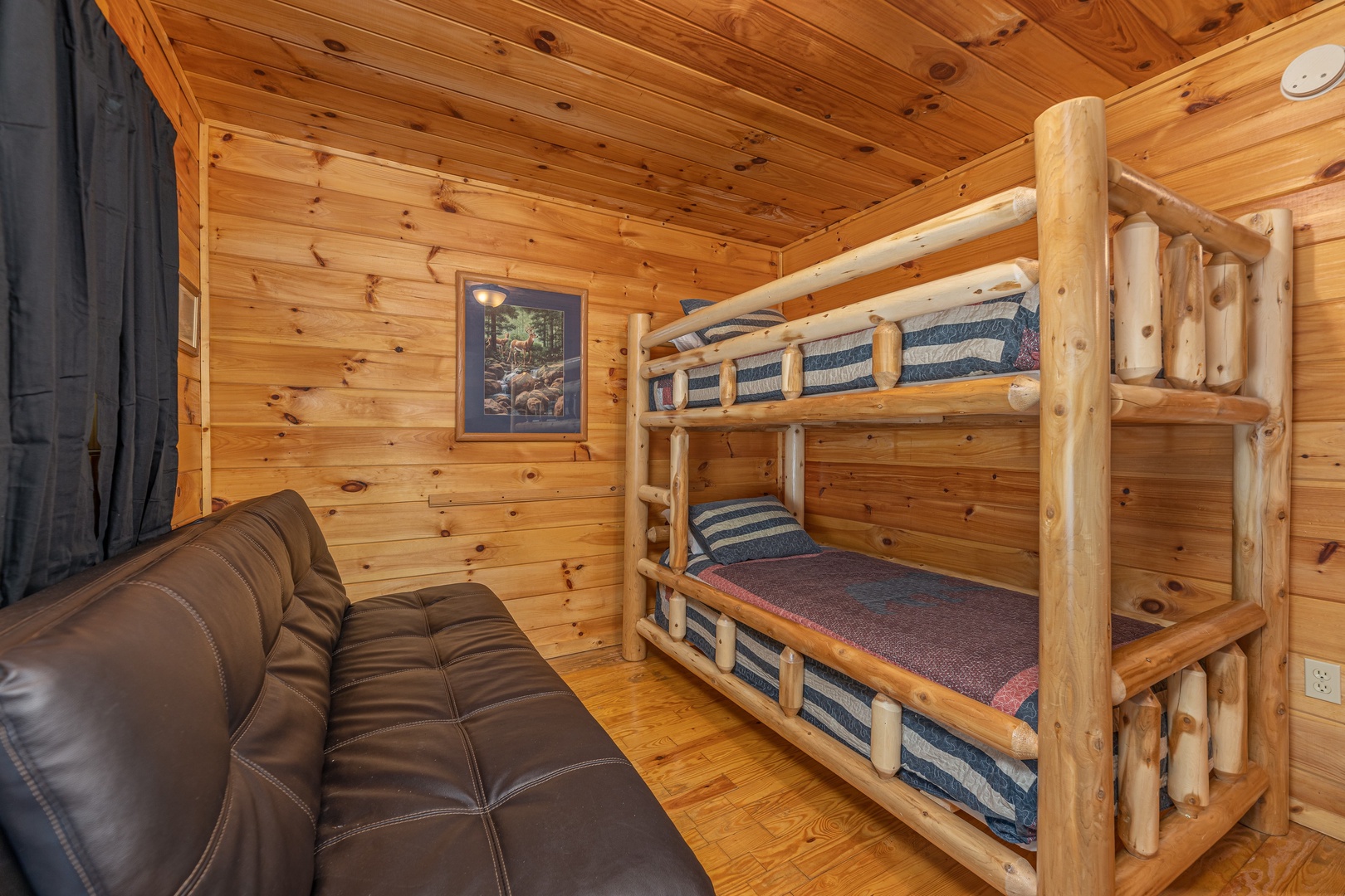 Bunk beds and futon at A Cheerful Heart, a 2 bedroom cabin rental located in Pigeon Forge