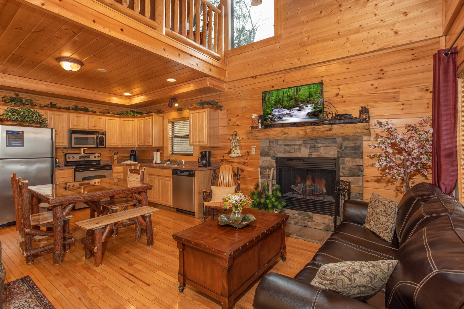 Living room, dining room, and kitchen at Let the Good Times Roll, a 2 bedroom cabin rental located in Pigeon Forge