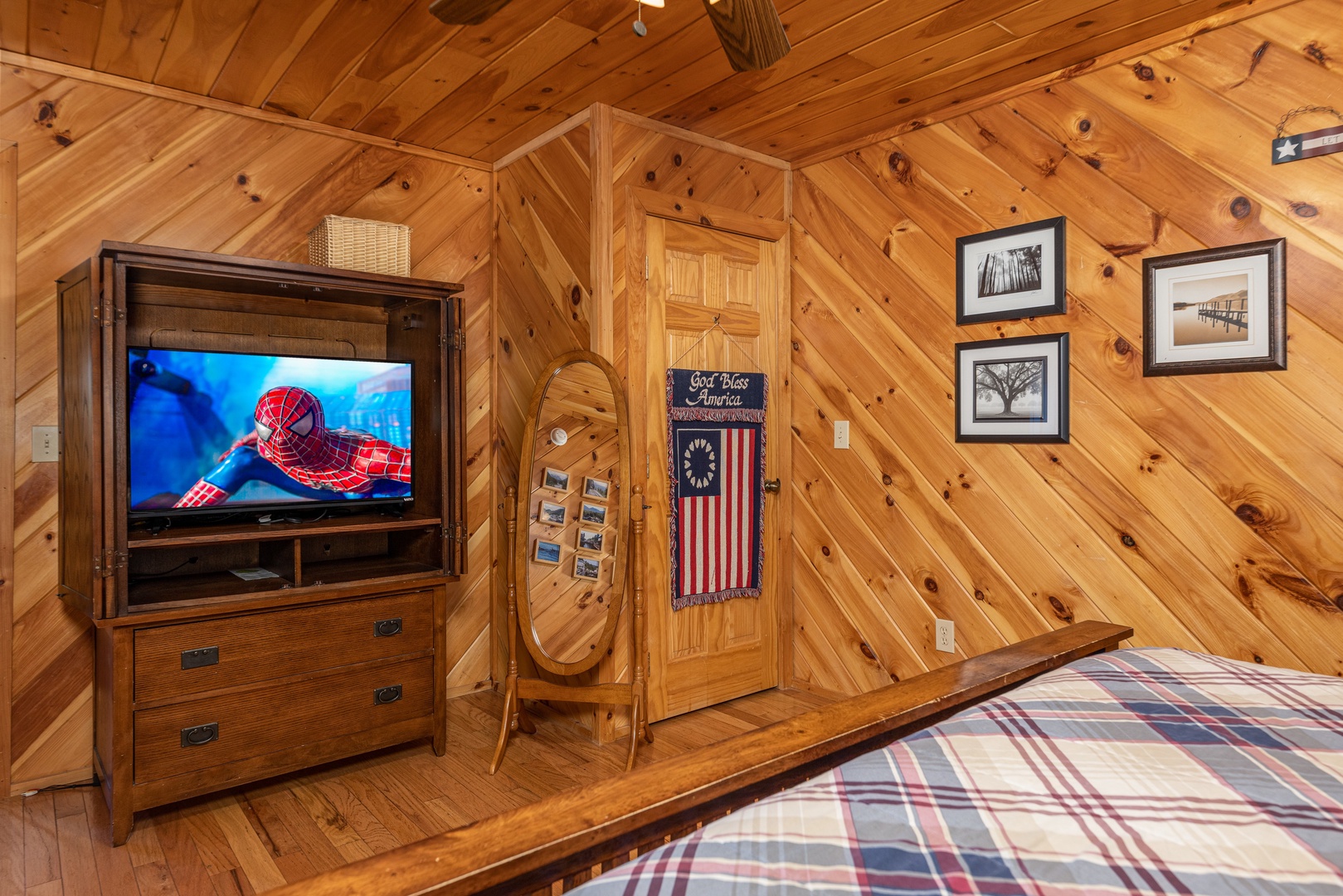 TV and armoir in a bedroom at Hatcher Mountain Retreat a 2 bedroom cabin rental located in Pigeon Forge