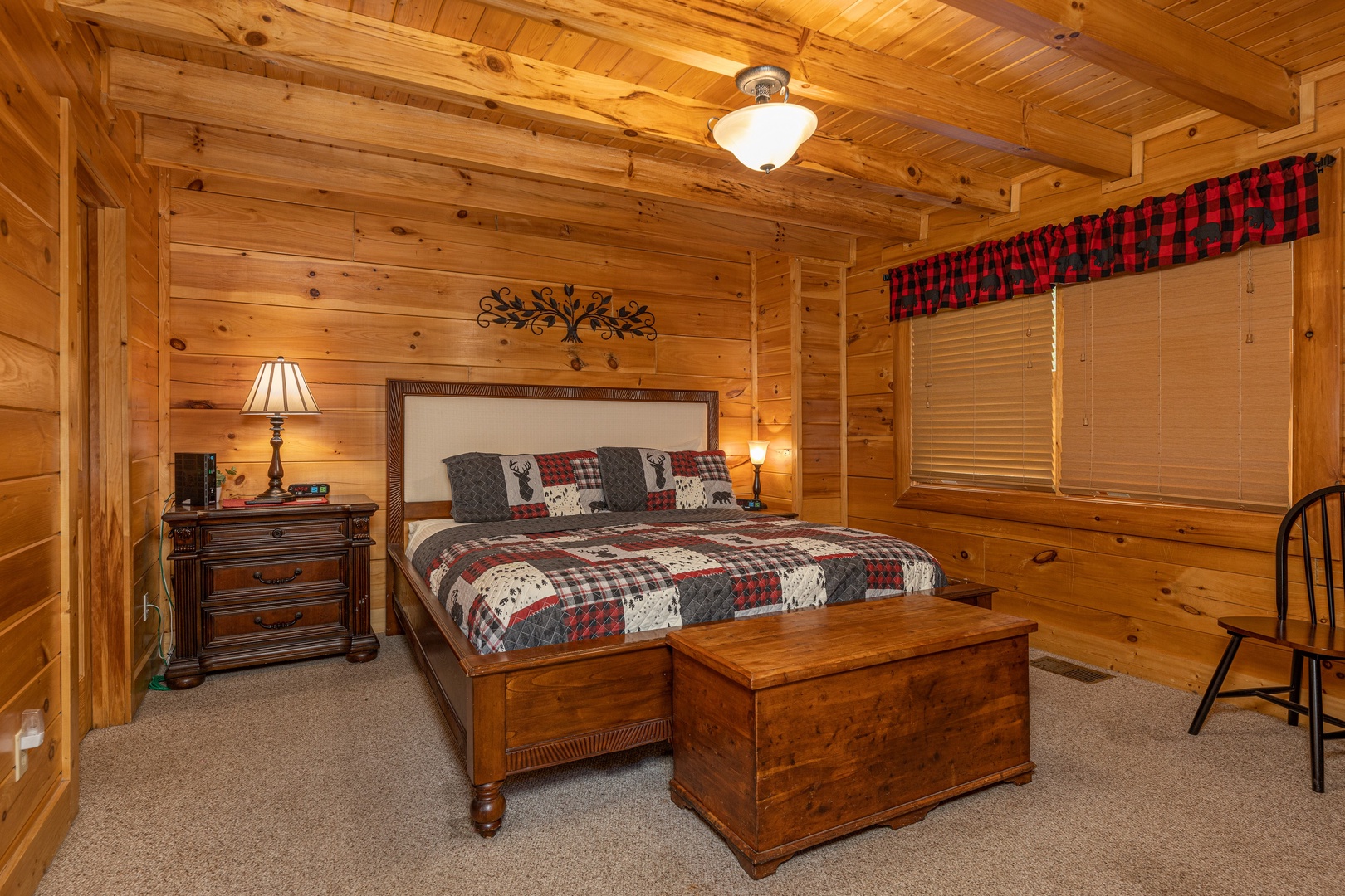 Bedroom with night stands, lamps, and chest at Absolutely Wonderful, a 2 bedroom cabin rental located in Pigeon Forge