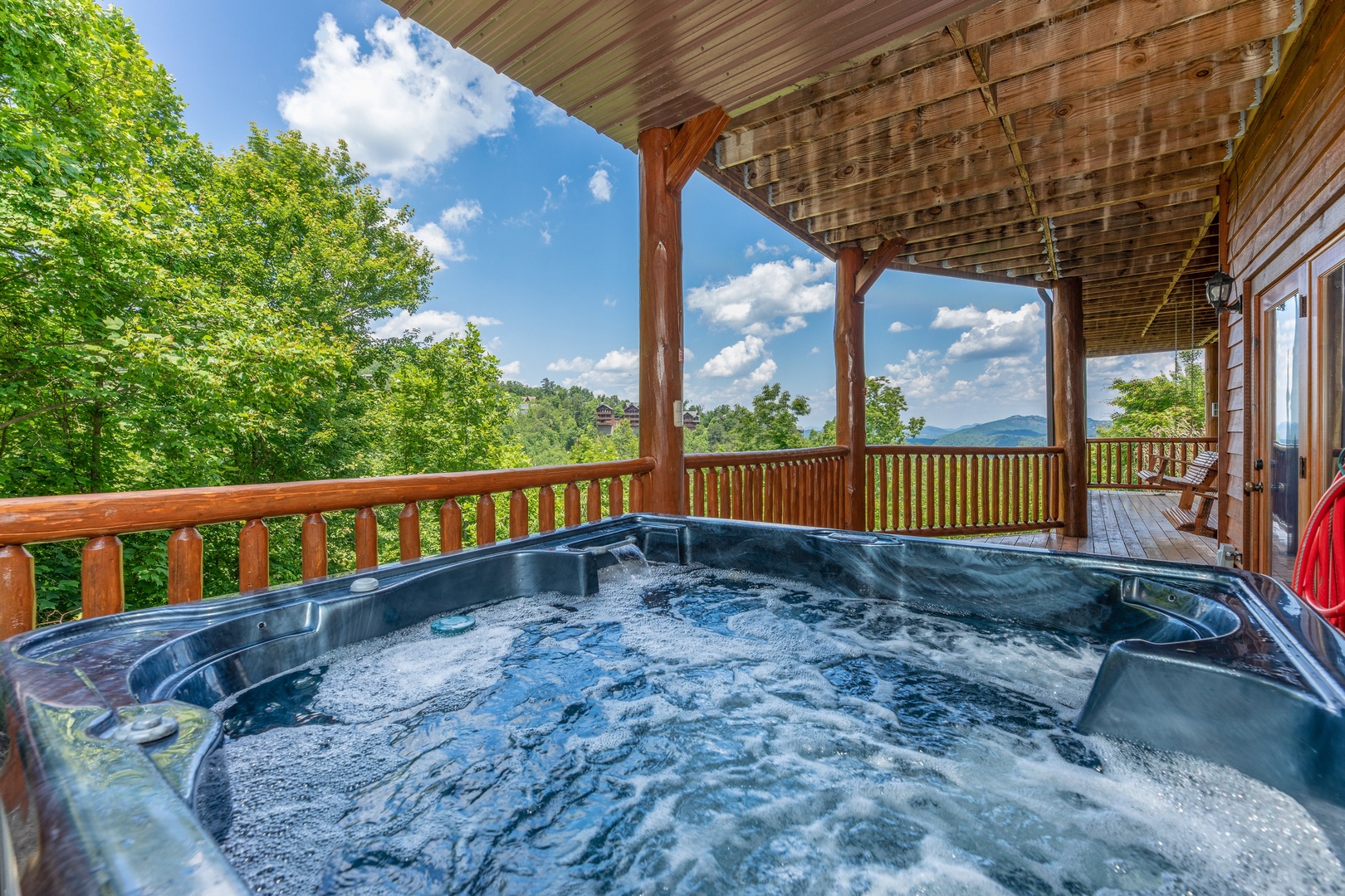 Looking out at the mountains from the hot tub at God's Country, a 4 bedroom cabin rental located in Pigeon Forge