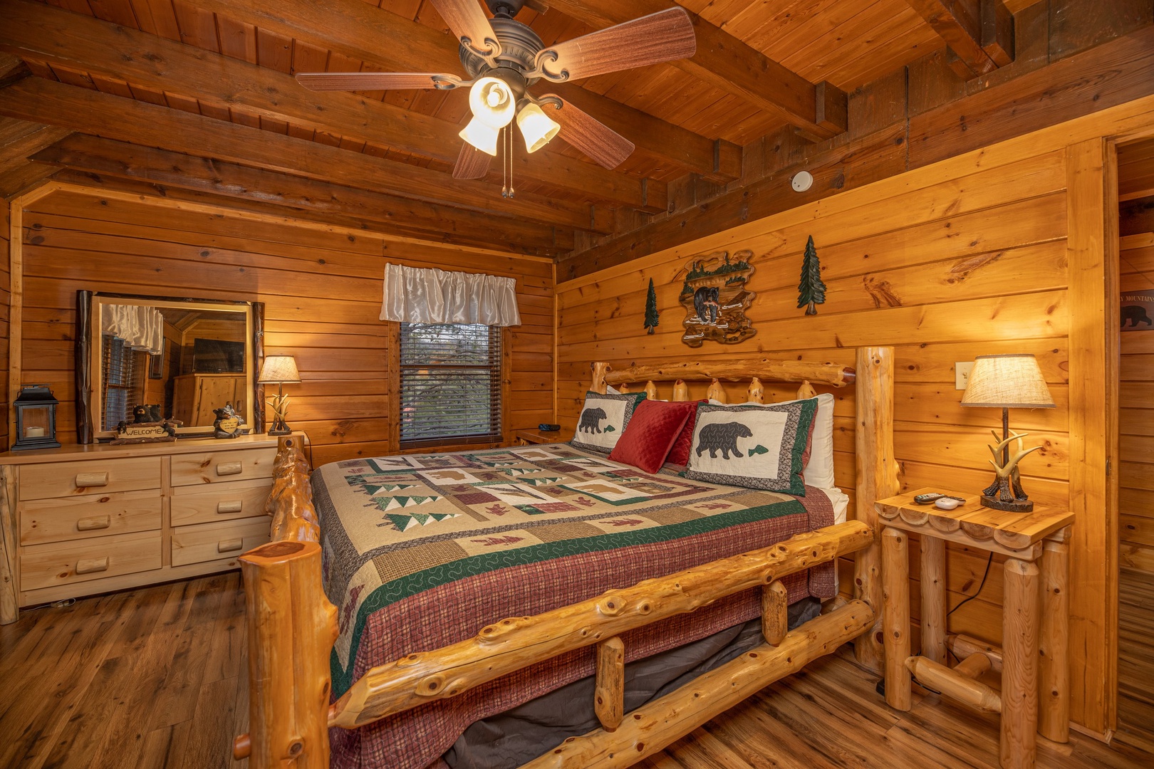 Bedroom with a log bed, night stand, and dresser at Pigeon Forge Pleasures, a 3 bedroom cabin rental located in Pigeon Forge