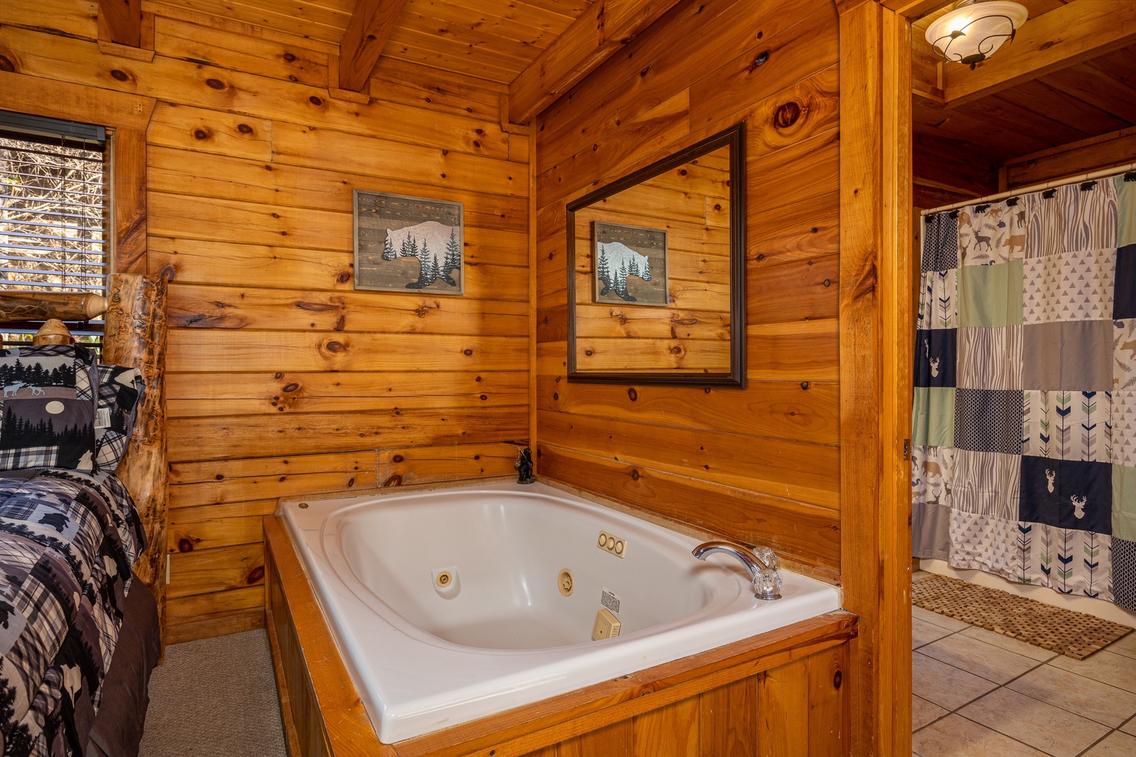 Bedroom jacuzzi at Bear Feet Retreat, a 1 bedroom cabin rental located in pigeon forge