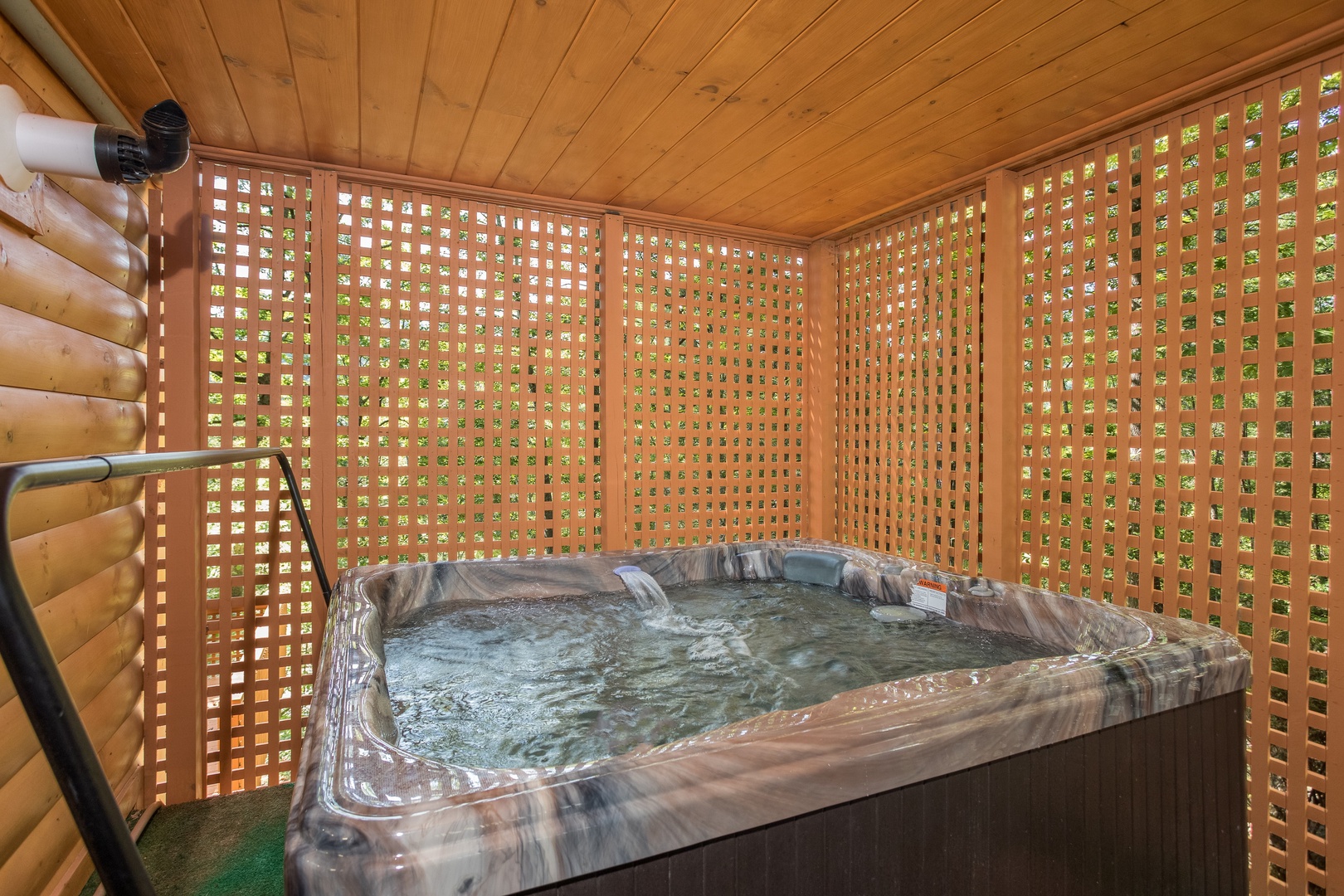 Hot tub with privacy fence at Forever Country, a 3 bedroom cabin rental located in Pigeon Forge