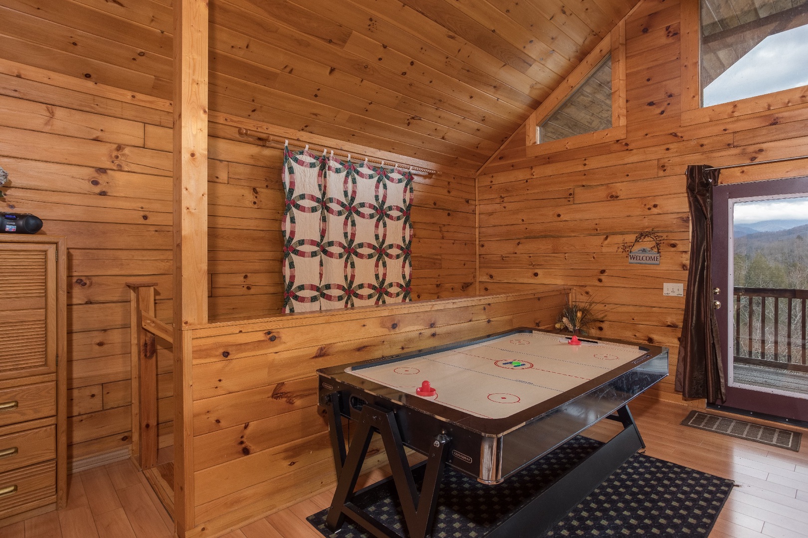 Air hockey table in the loft bedroom at Precious View, a 1 bedroom cabin rental located in Gatlinburg