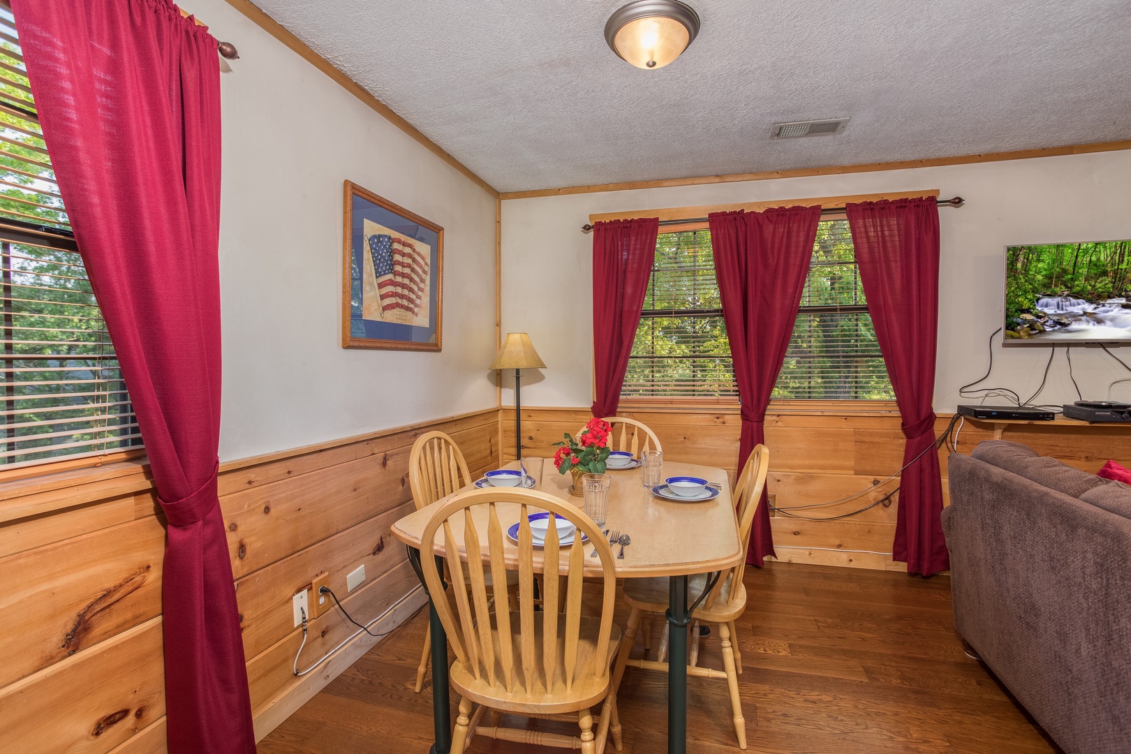 Dining table for four in the living room at Patriot Pointe, a 5 bedroom cabin rental located in Pigeon Forge