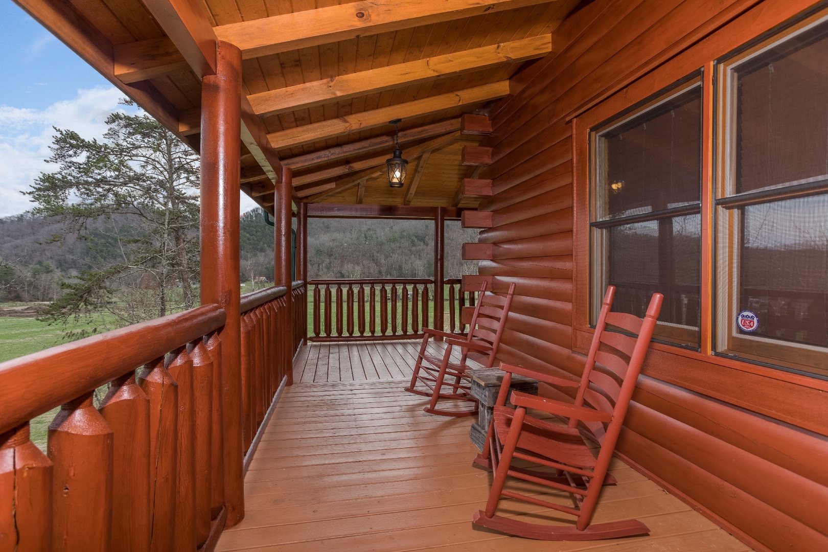 Rocking chairs on the covered deck at Mountain View Meadows, a 3 bedroom cabin rental located in Pigeon Forge