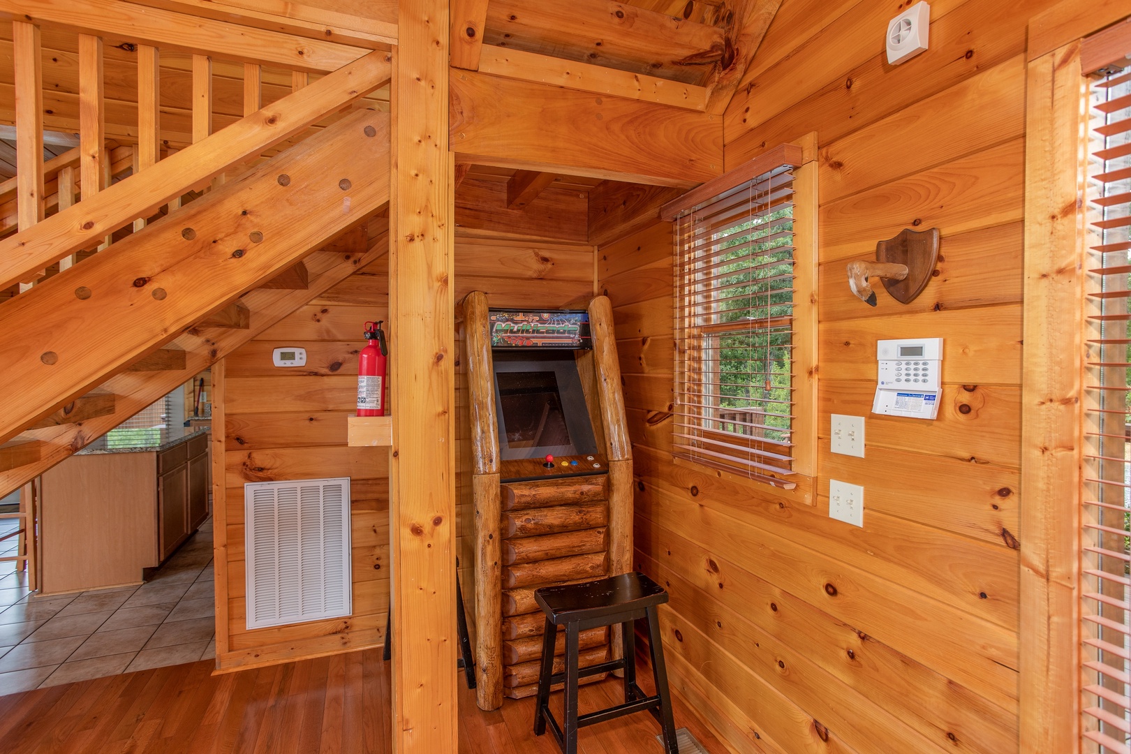 Arcade game in the living room at Four Seasons Lodge, a 3-bedroom cabin rental located in Pigeon Forge
