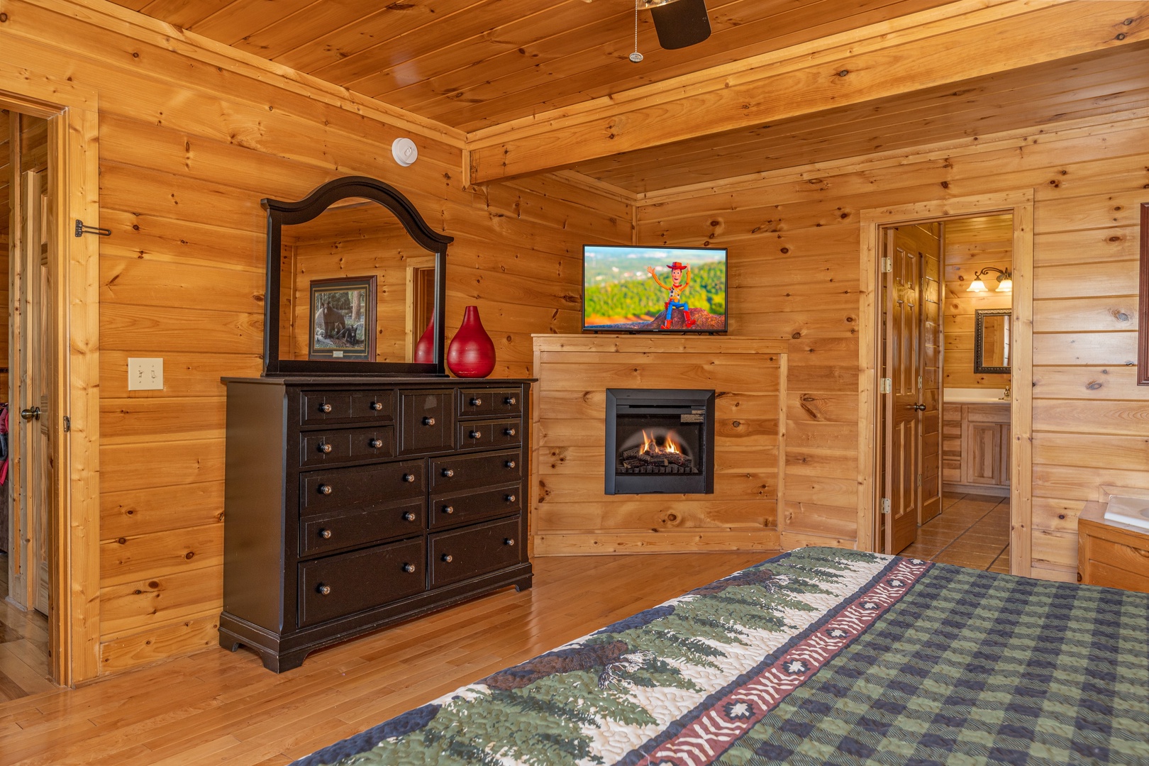Dresser, fireplace, and TV in a bedroom at Bears Don't Bluff, a 3 bedroom cabin rental located in Pigeon Forge