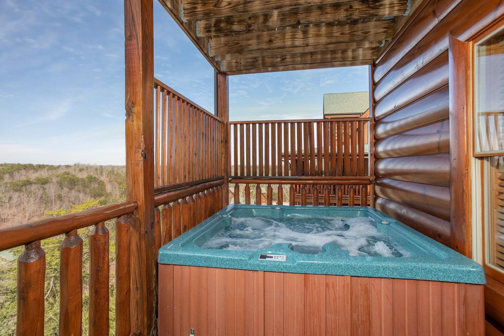 Hot tub on a covered deck at Better View, a 4 bedroom cabin rental located in Pigeon Forge