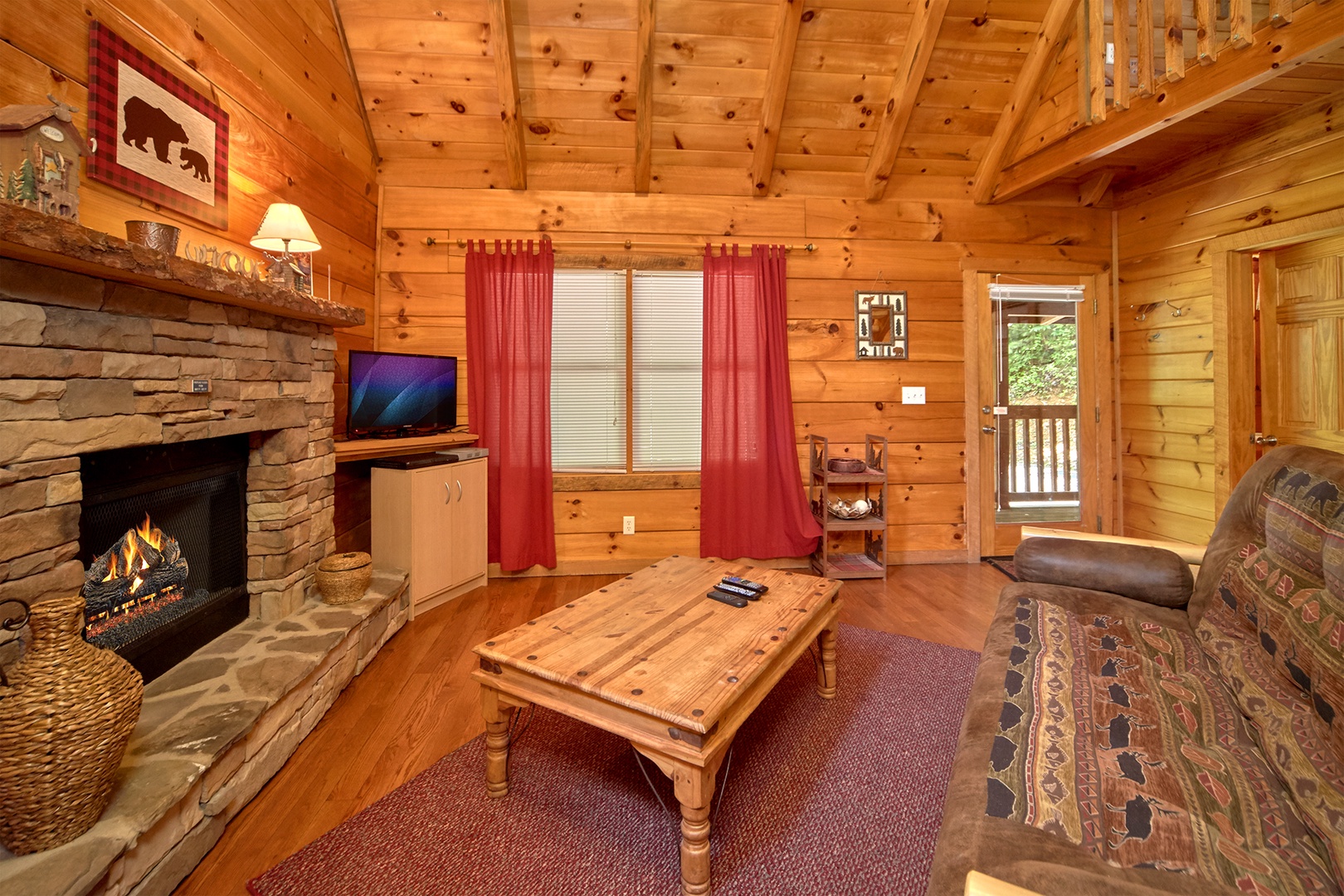 Fireplace and TV in a living room at Wild Crush, a 1 bedroom cabin rental located in Pigeon Forge