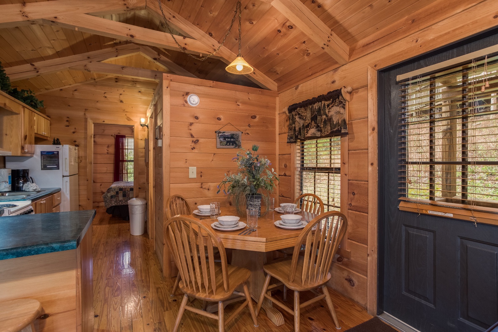 Dining table with seating for four at Boogie Bear, a 1-bedroom cabin rental located in Gatlinburg