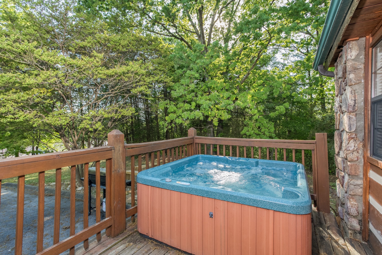 Hot tub on a deck at Patriot Pointe, a 5 bedroom cabin rental located in Pigeon Forge