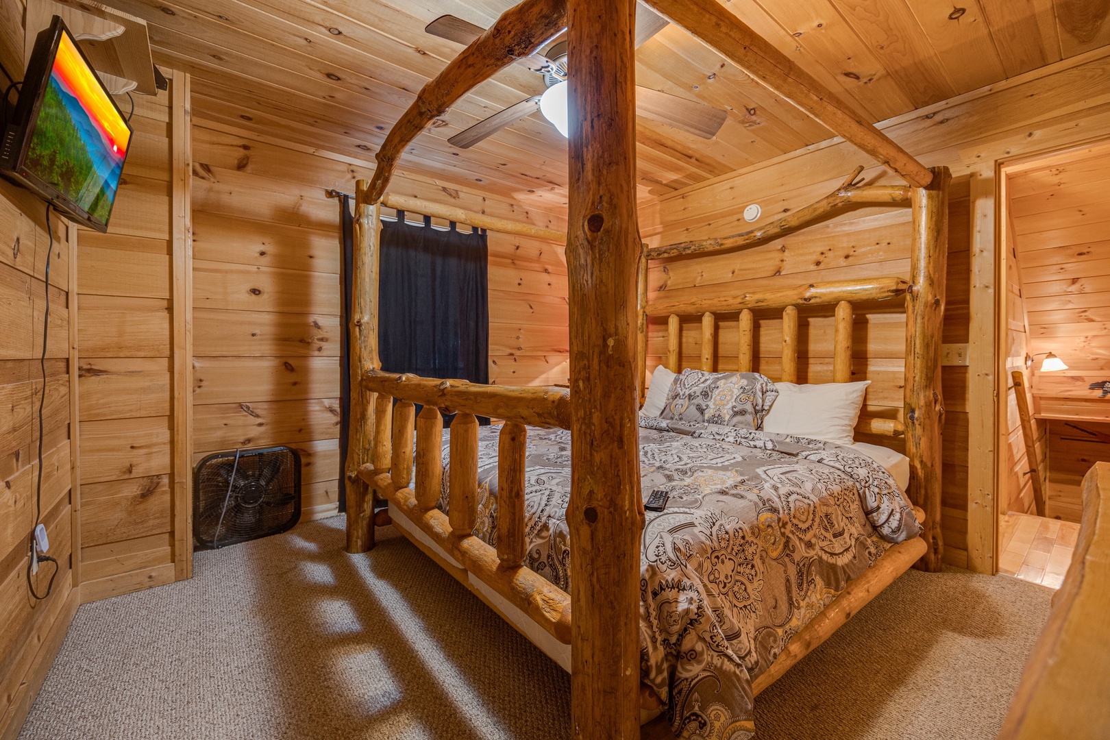 Master bedroom with log bed at Lazy Bear Lodge