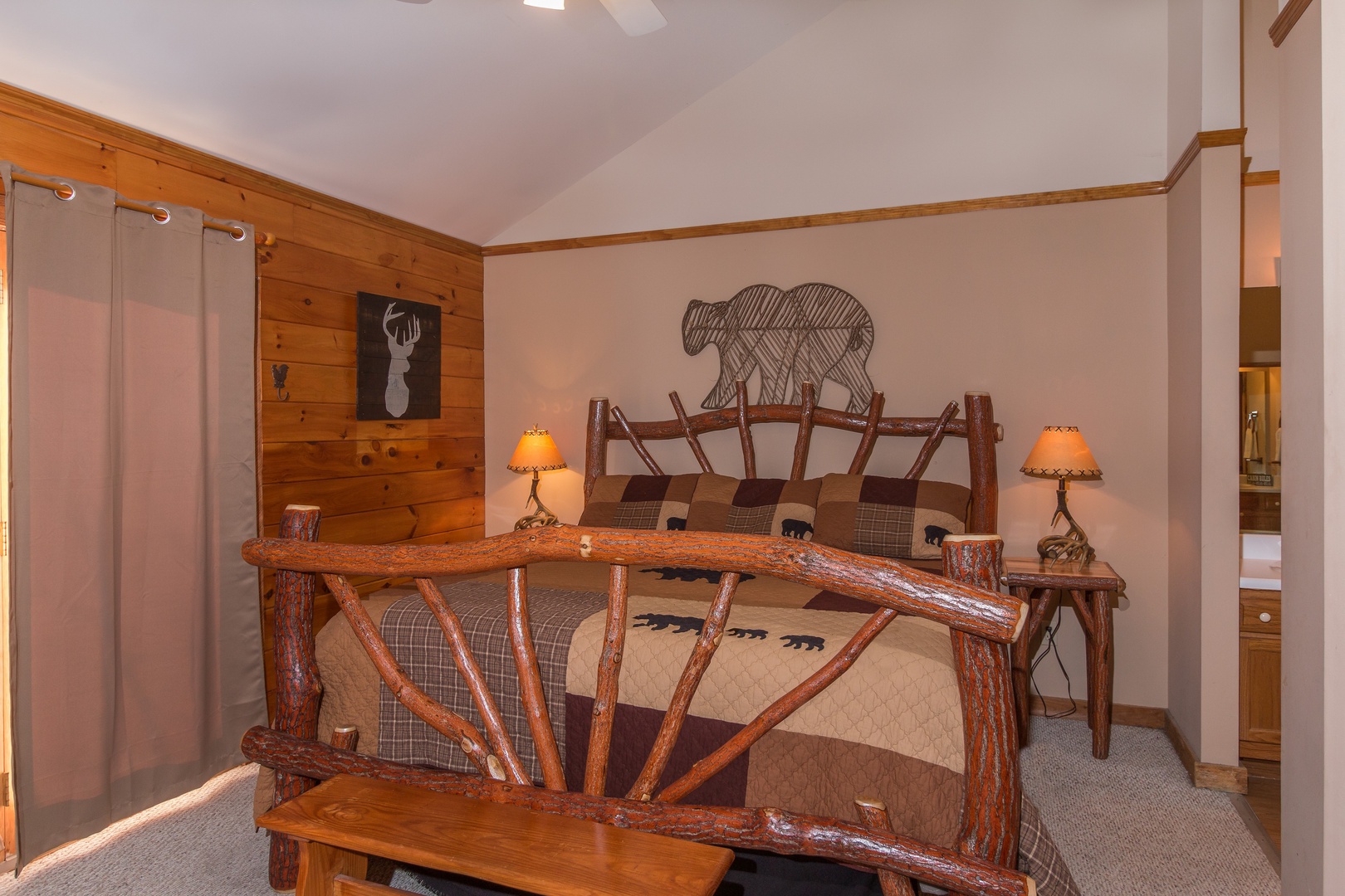Bedroom with a log bed, night stands, and lamps at Just for Fun, a 4 bedroom cabin rental located in Pigeon Forge