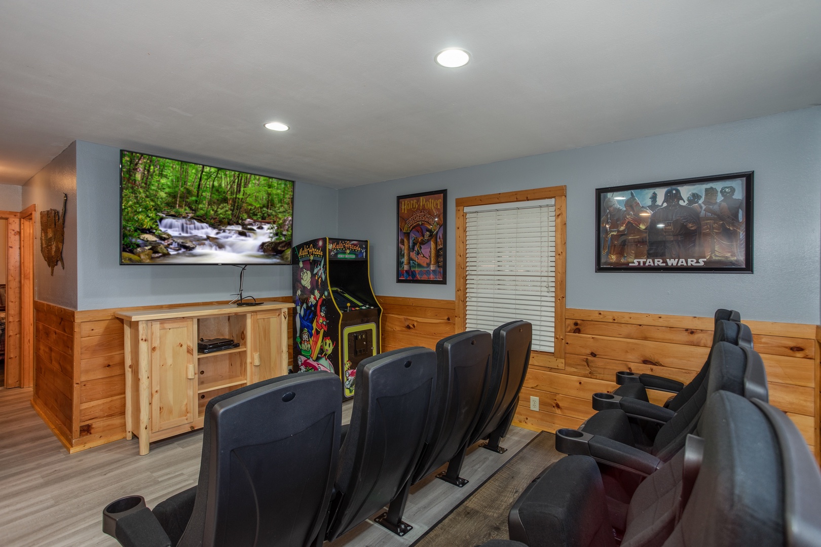 TV and arcade game in the theater room at Mountain Music, a 5 bedroom cabin rental located in Pigeon Forge