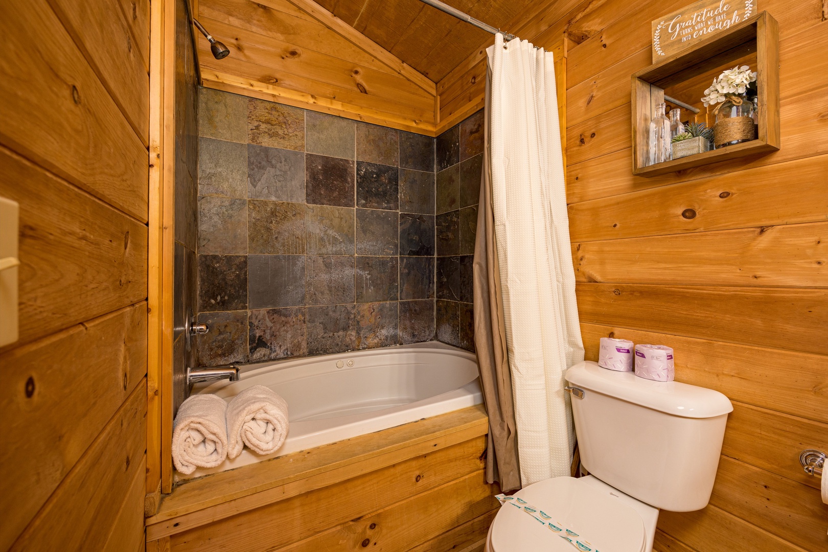 Bathtub and shower at Bearstone Cabin, a 1 bedroom cabin rental located in Gatlinburg