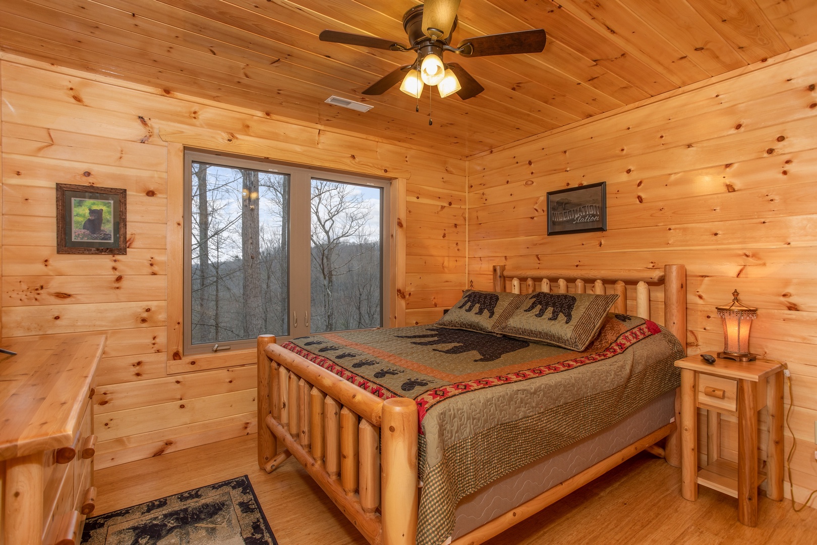 Bedroom with king bed and night stand at Happy Bear's Hideaway, a 2 bedroom cabin rental located in Gatlinburg