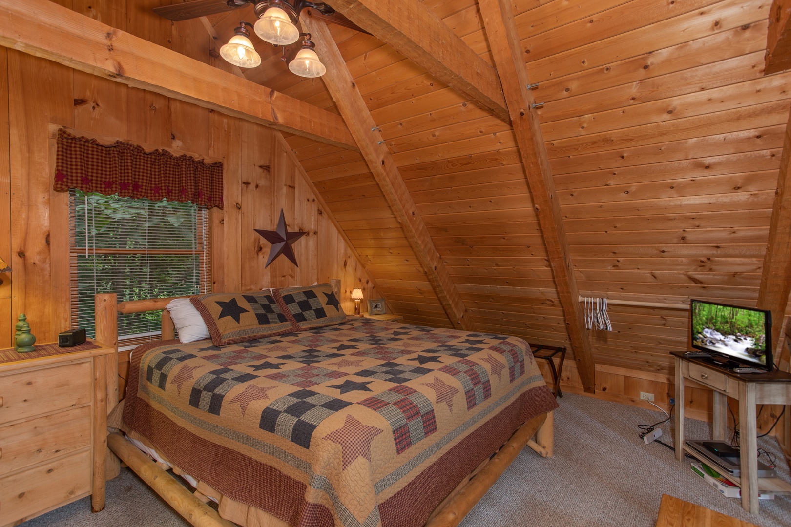 King-sized bed in the loft at Bearfoot Crossing, a 1-bedroom cabin rental located in Pigeon Forge