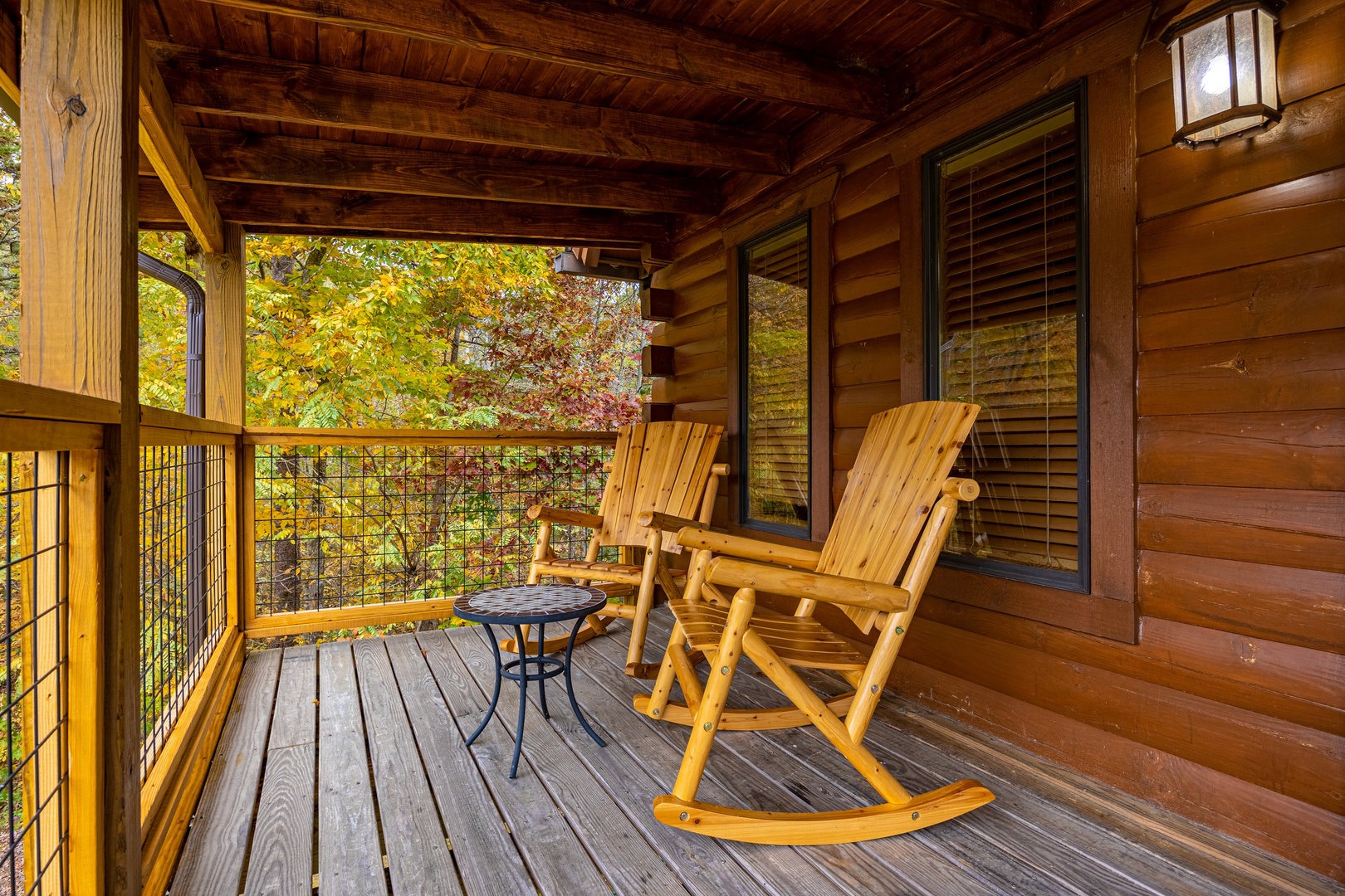 Rocking Chairs Under Covered Deck at Mountain Lake Getaway, a 3 bedroom cabin rental located in douglas lake