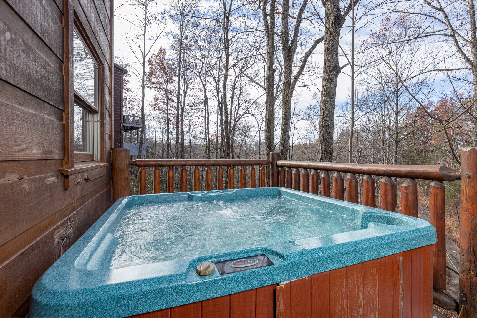 Hot tub on a deck at Fallin' in Love, a 1 bedroom cabin rental located in Gatlinburg