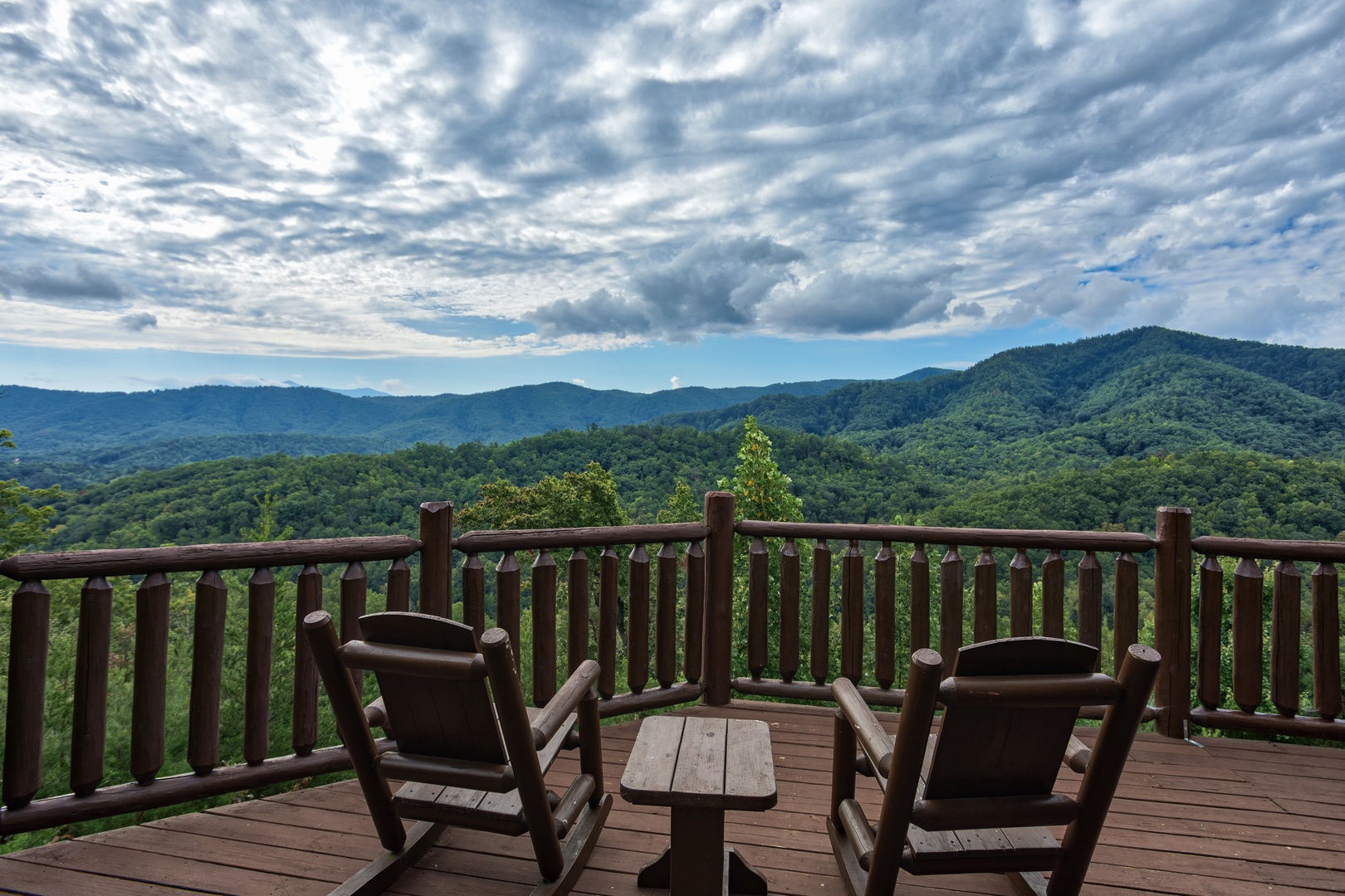 Rocking chairs on a deck at Majestic Views, a 3 bedroom cabin rental located in Pigeon Forge