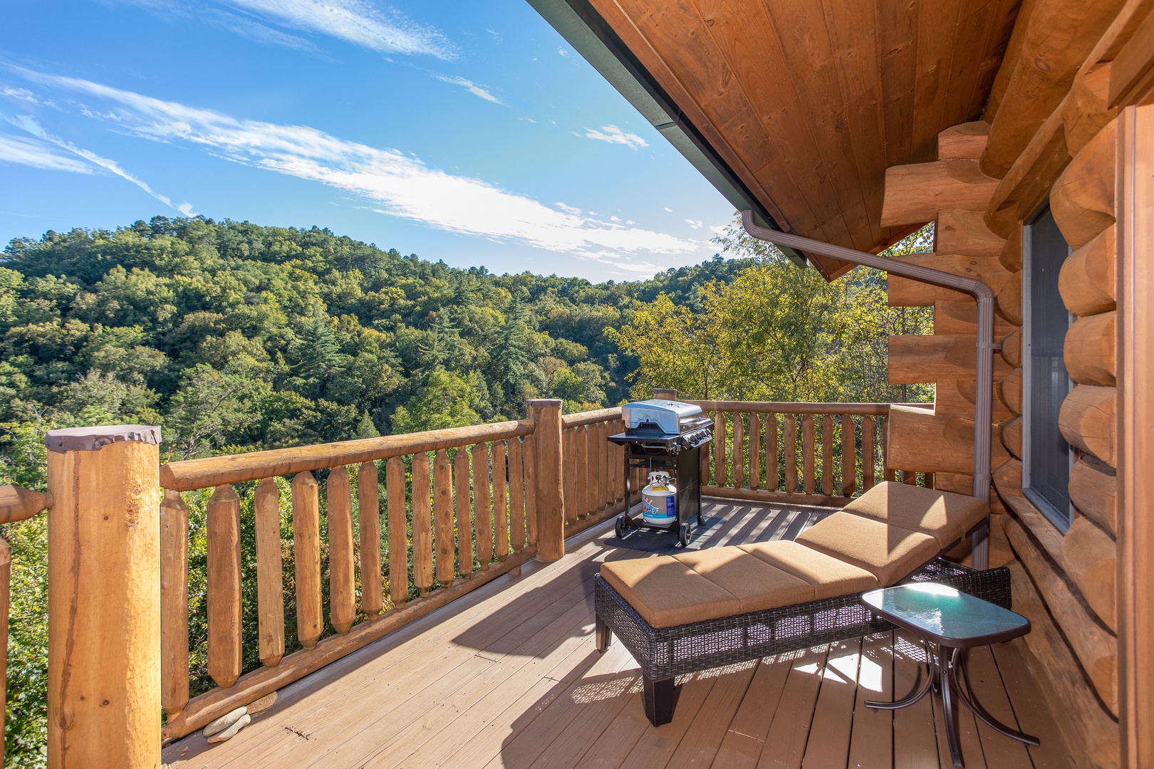 A chaise lounge on the deck overlooking the mountains at Great View Lodge, a 5-bedroom cabin rental located in Pigeon Forge