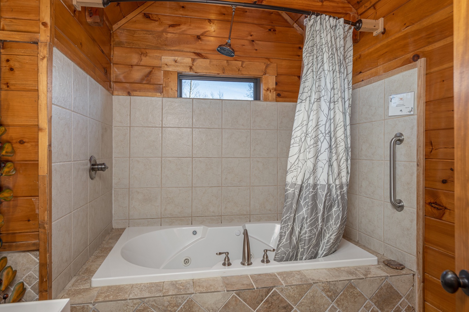 Bathroom with a jacuzzi and shower at King of the Mountain, a 3 bedroom cabin rental located in Pigeon Forge