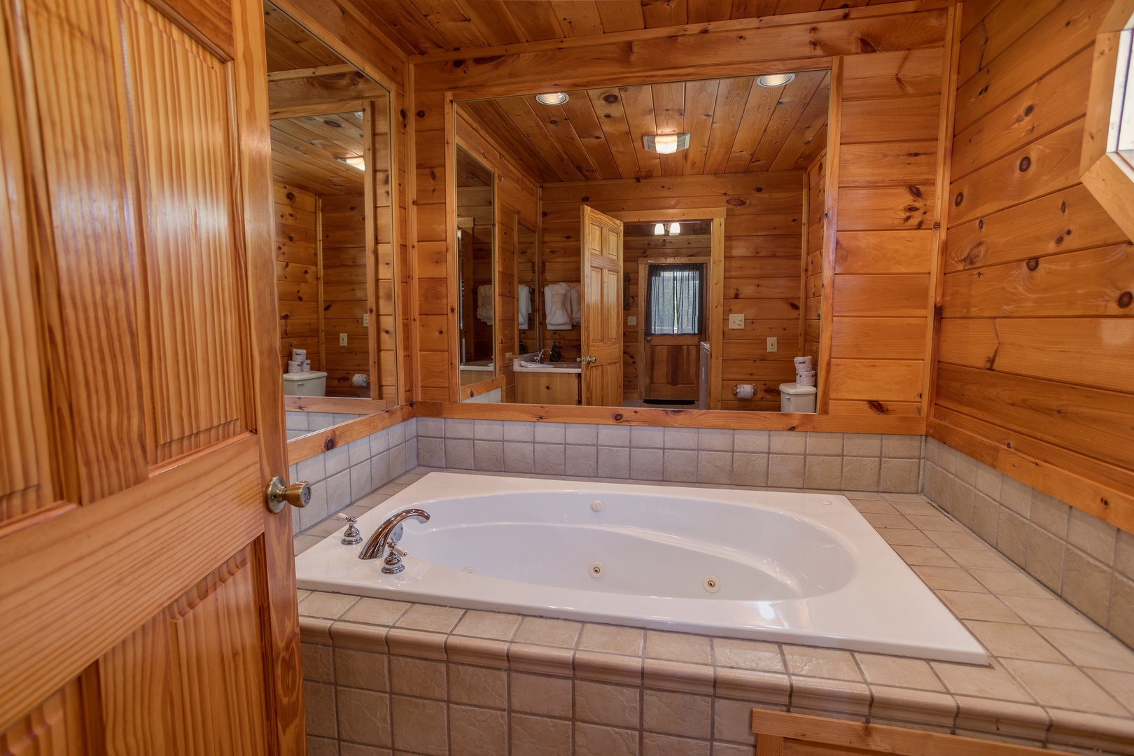 Jacuzzi tub with a mirrored surround at Cabin Fever, a 4-bedroom cabin rental located in Pigeon Forge