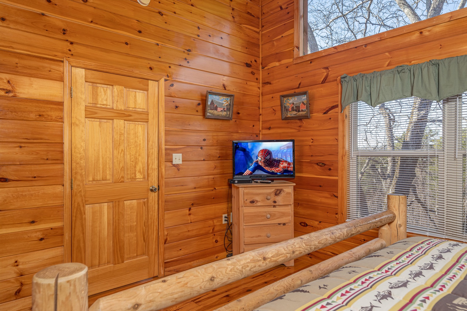 Bedroom with dresser and TV at Hickernut Lodge, a 5-bedroom cabin rental located in Pigeon Forge