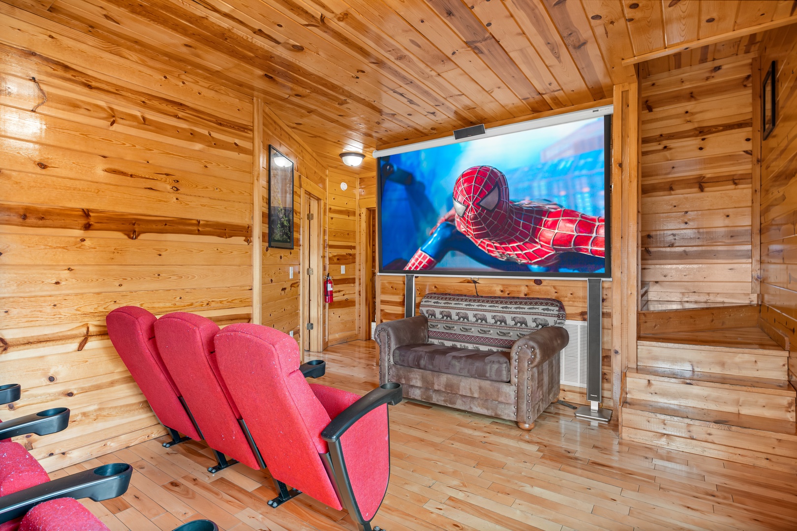 Theater room seats and Flat Screen at Natural Wonder, a 4 bedroom cabin rental located in Gatlinburg