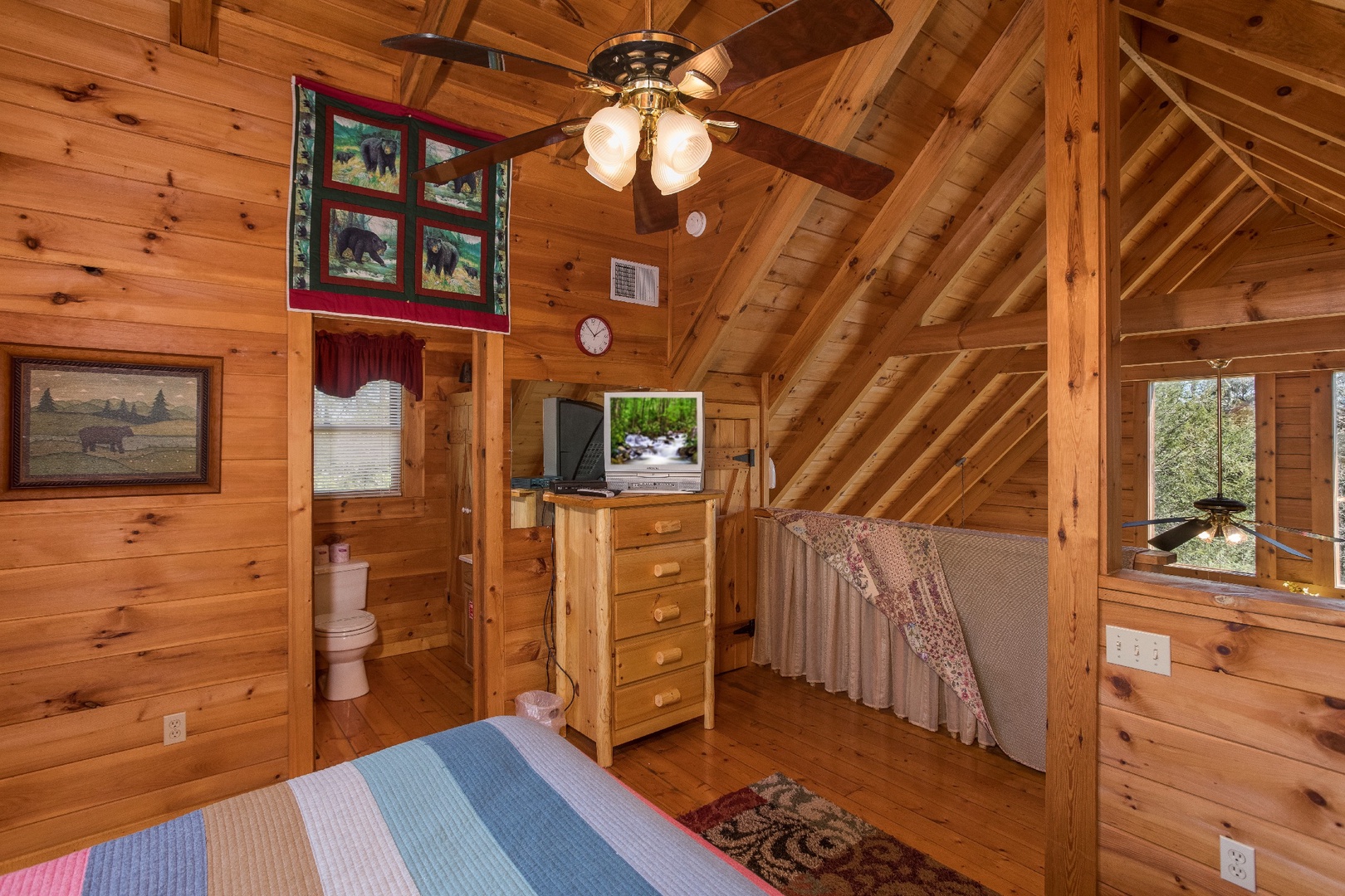 Television, dresser, and en suite in the loft at Cloud 9, a 1-bedroom cabin rental located in Pigeon Forge