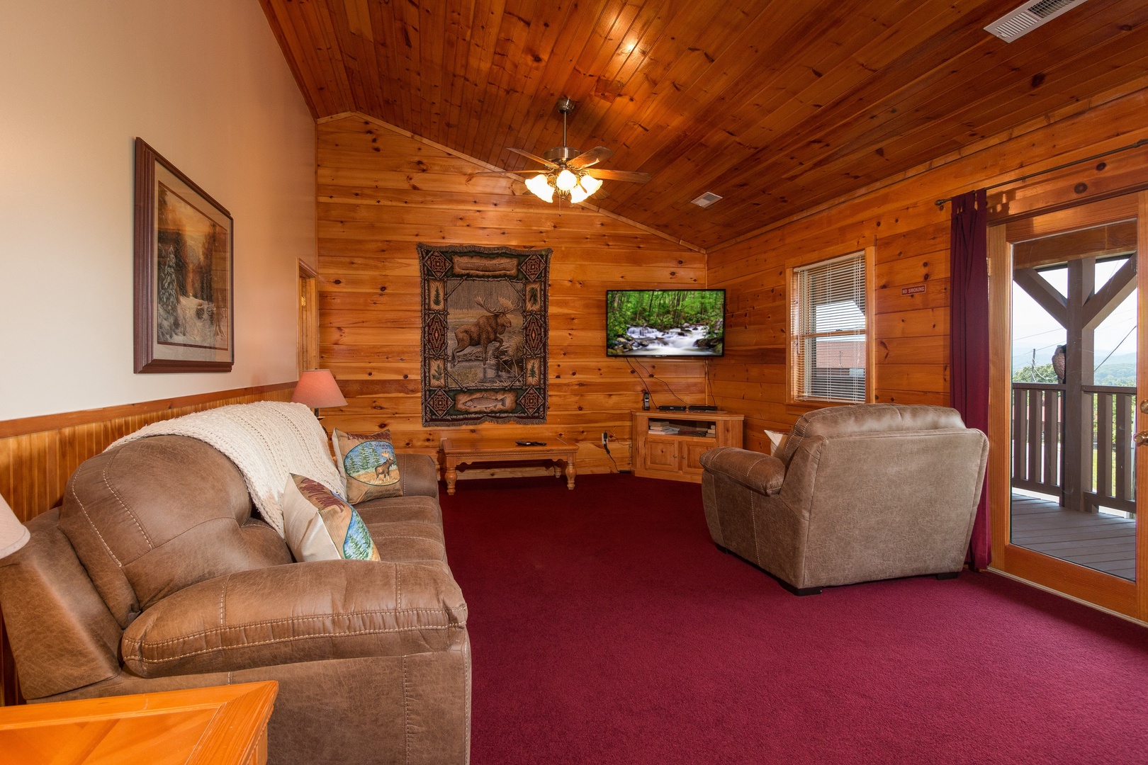Living room with a TV and deck access at Moose Lodge, a 4 bedroom cabin rental located in Sevierville
