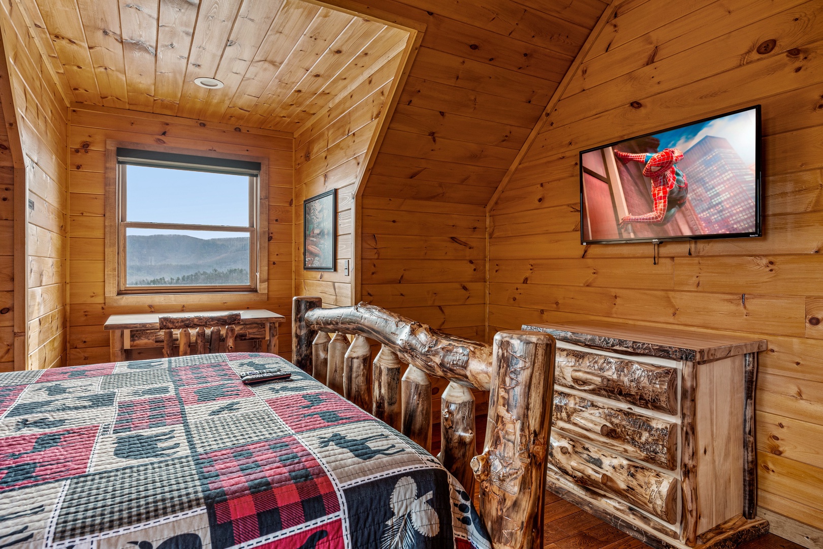 Log bedroom with mountain view at Four Seasons Grand, a 5 bedroom cabin rental located in Pigeon Forge